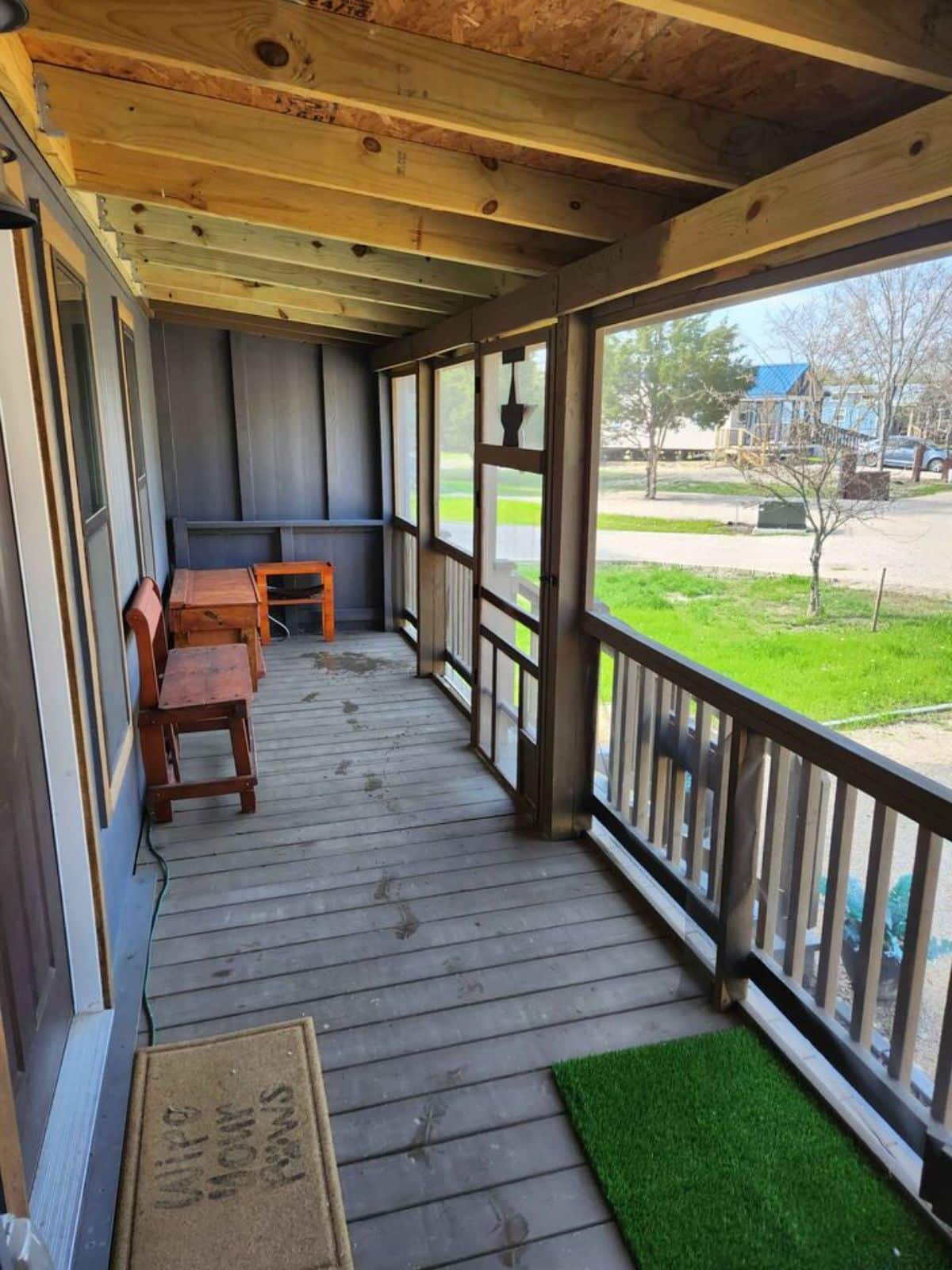 huge porch outside the main entrance of cottage tiny home