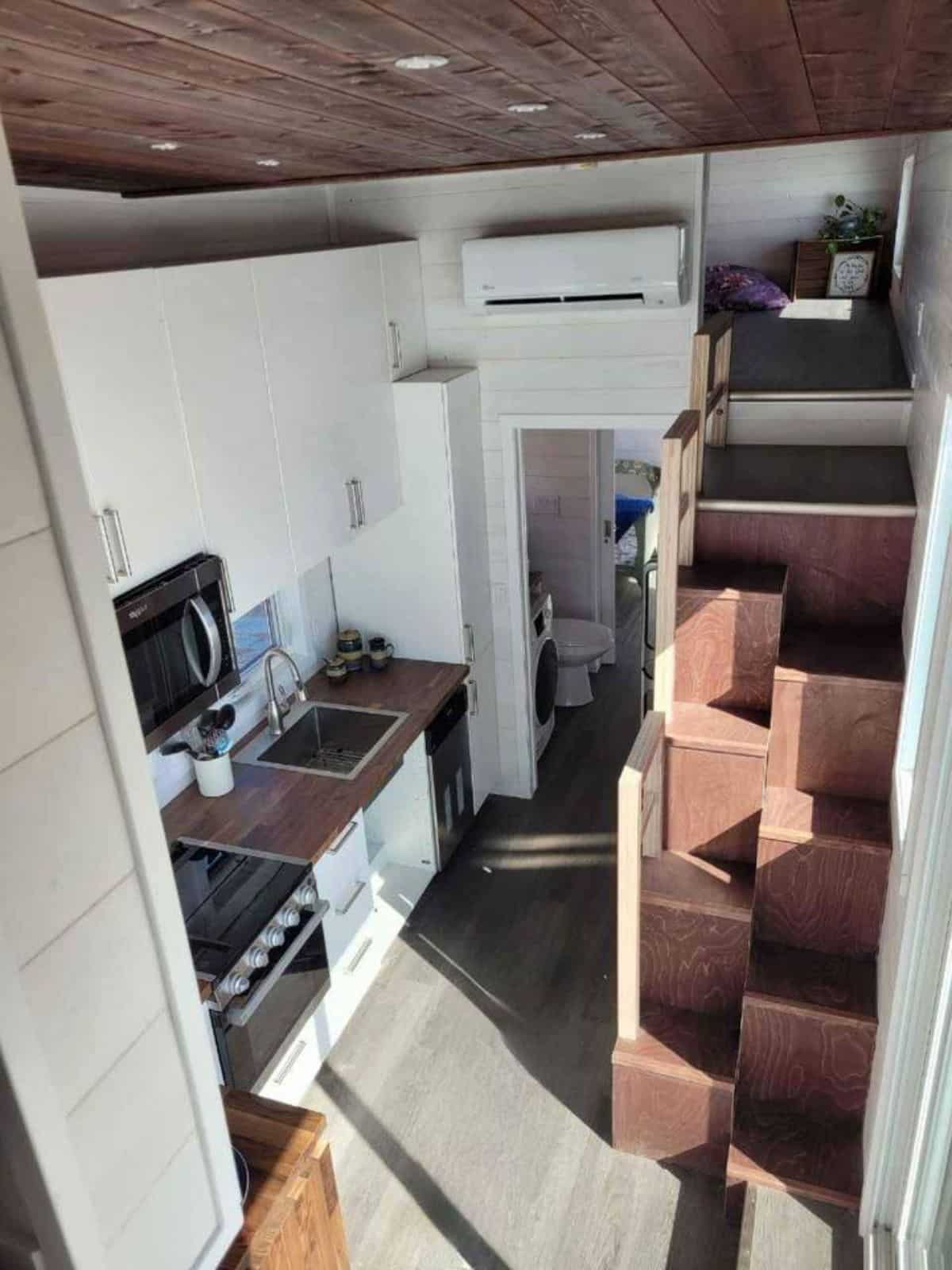 beautifully designed stairs with all white interiors of Willow model tiny home