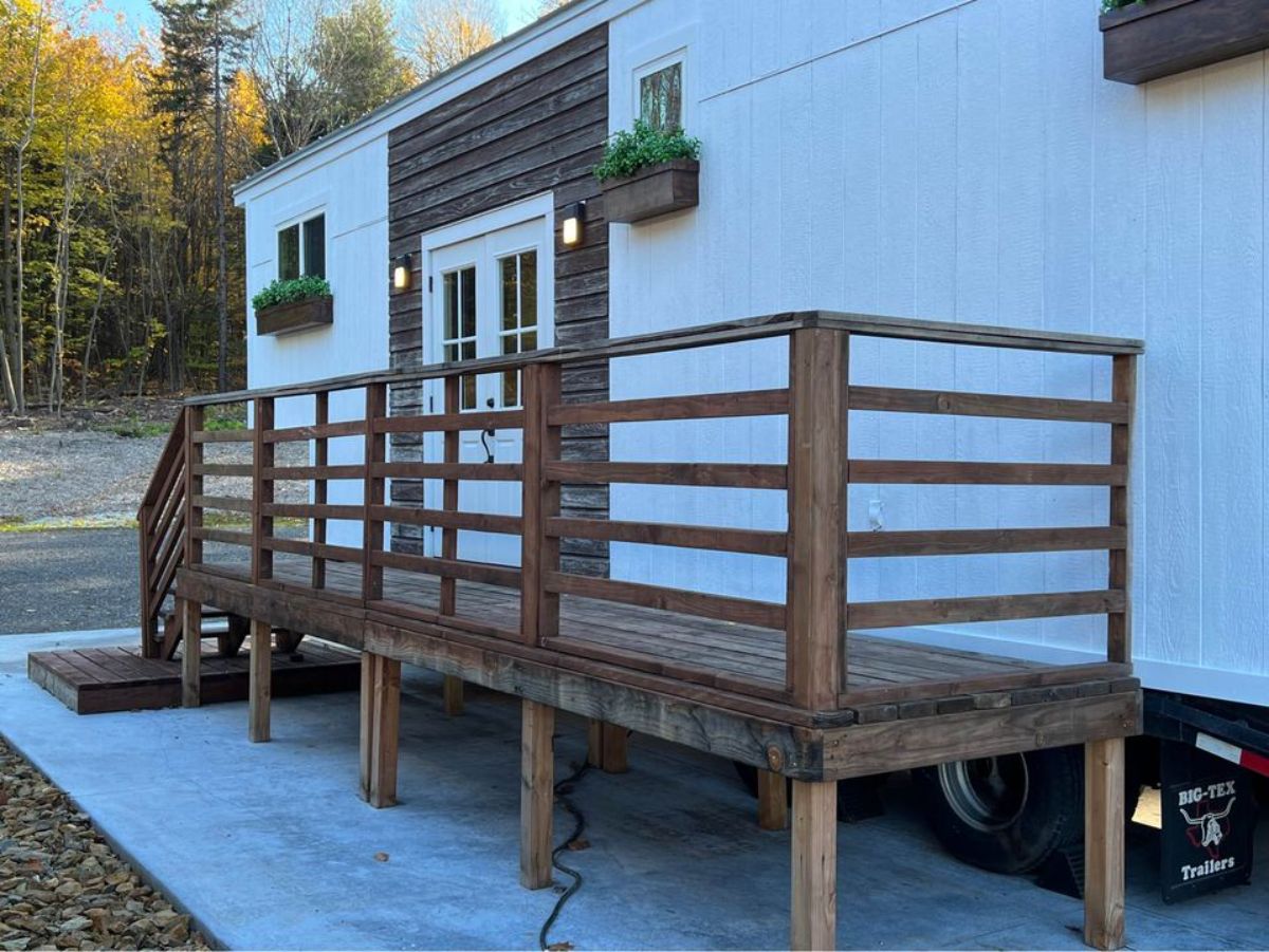 huge long porch outside the main entrance of 35’ tiny house