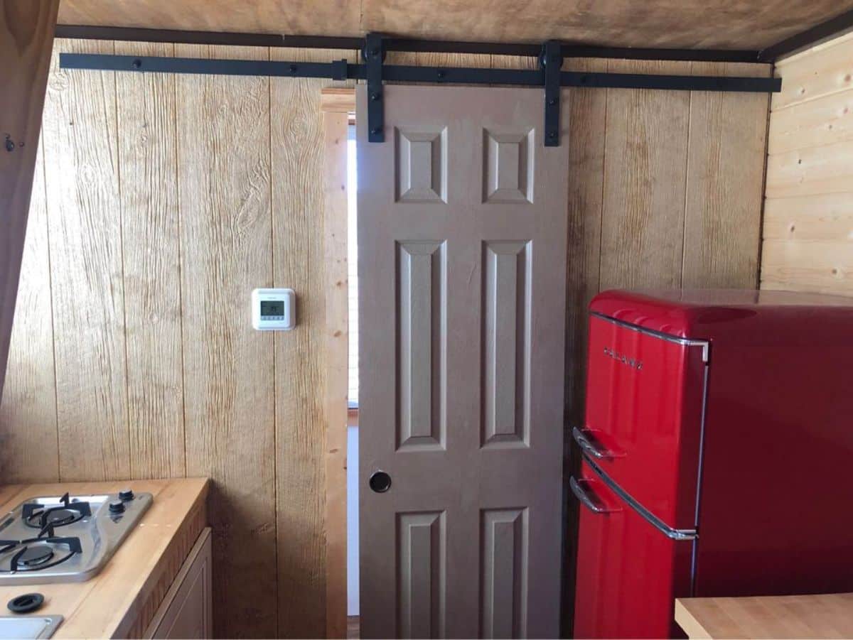 double door refrigerator and sliding door towards the bathroom