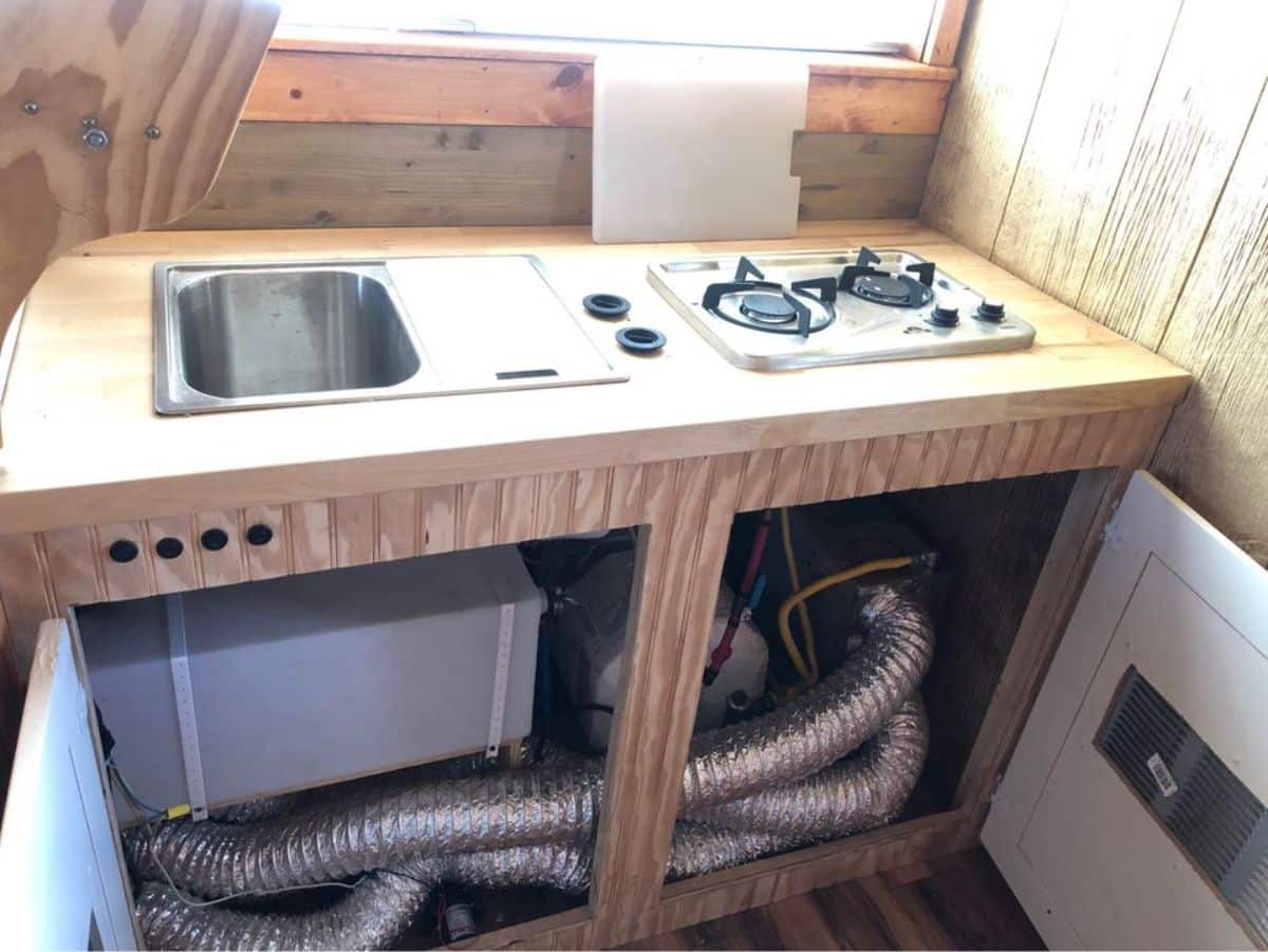 kitchen is double galley with one side having stove and sink