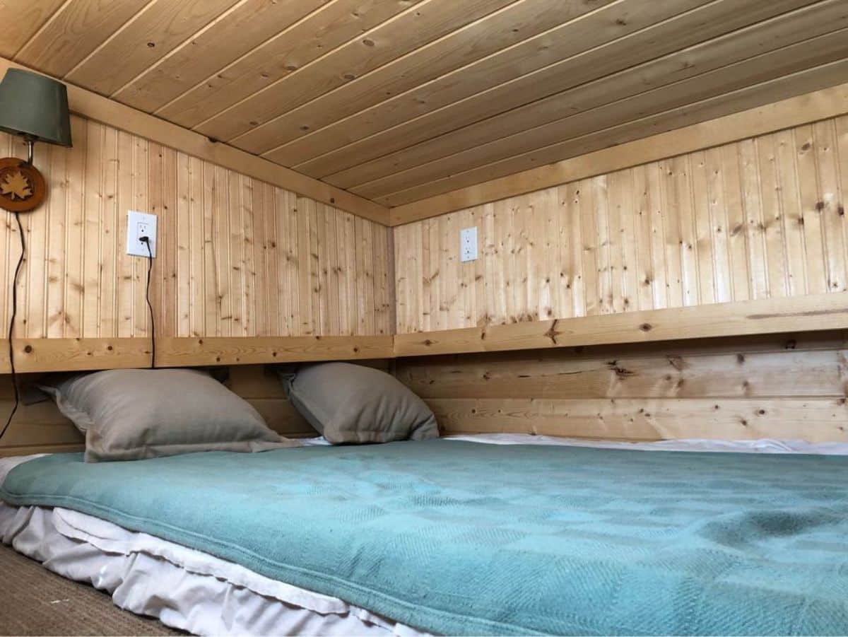 loft bedroom of professionally designed tiny home has a comfortable couch