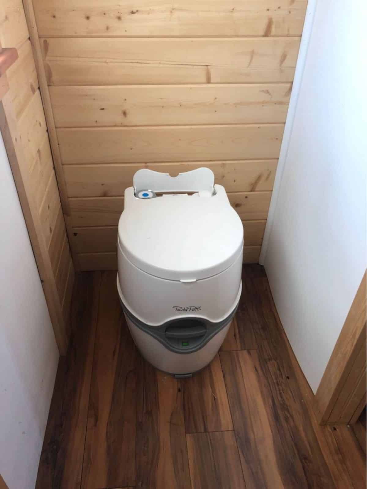 port a potty installed in the bathroom of professionally designed tiny home