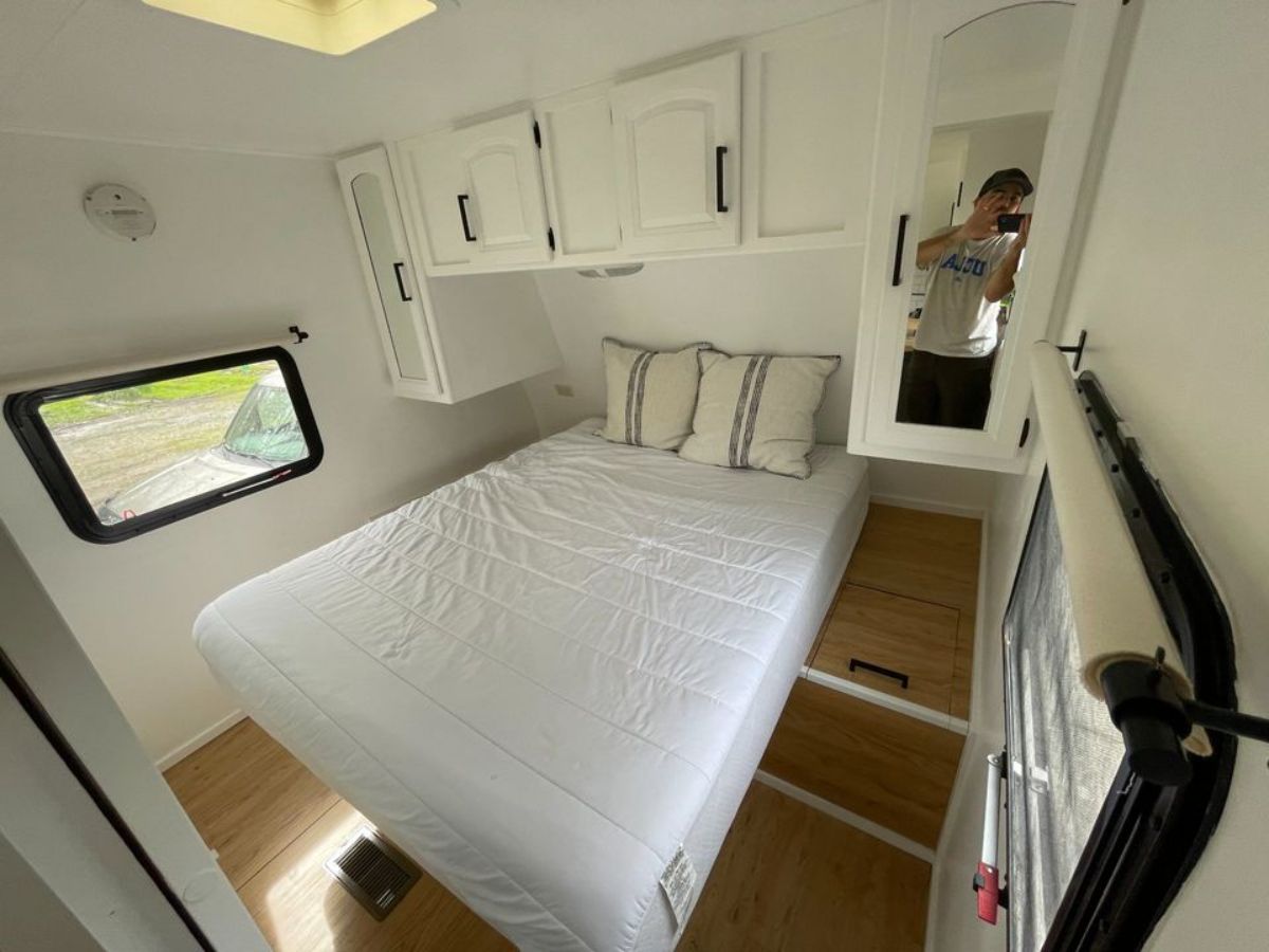huge bedroom has a comfortable bed with storage cabinets