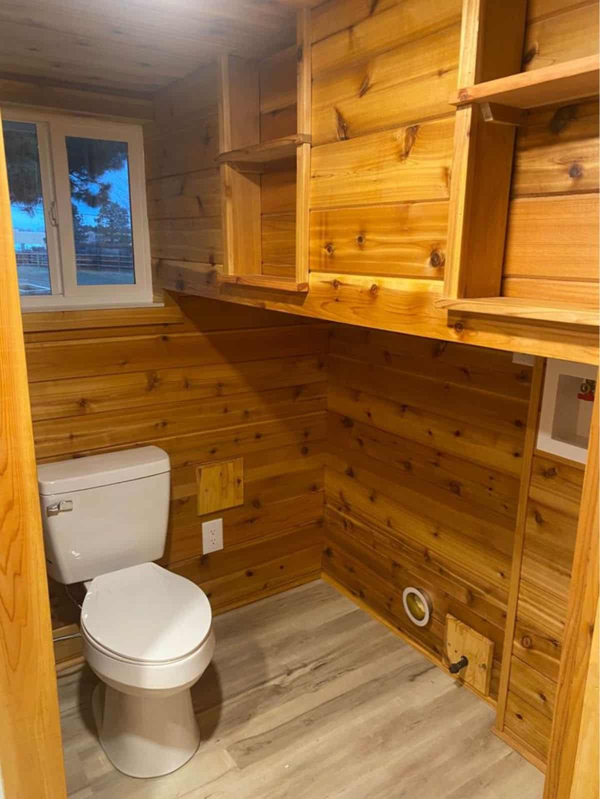 storage cabinets on the left toilet