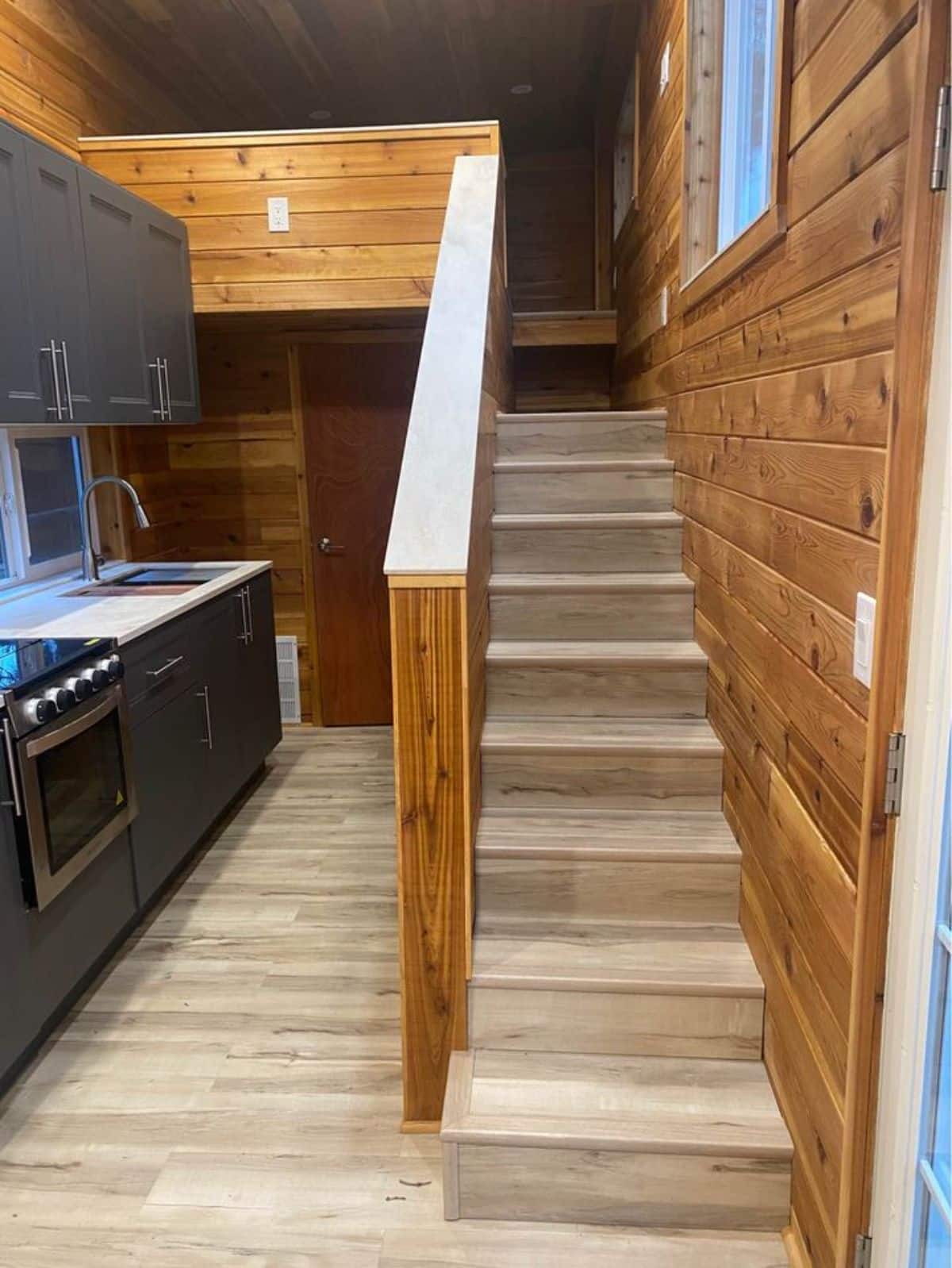 stairs leading to the main loft of double lofted tiny home