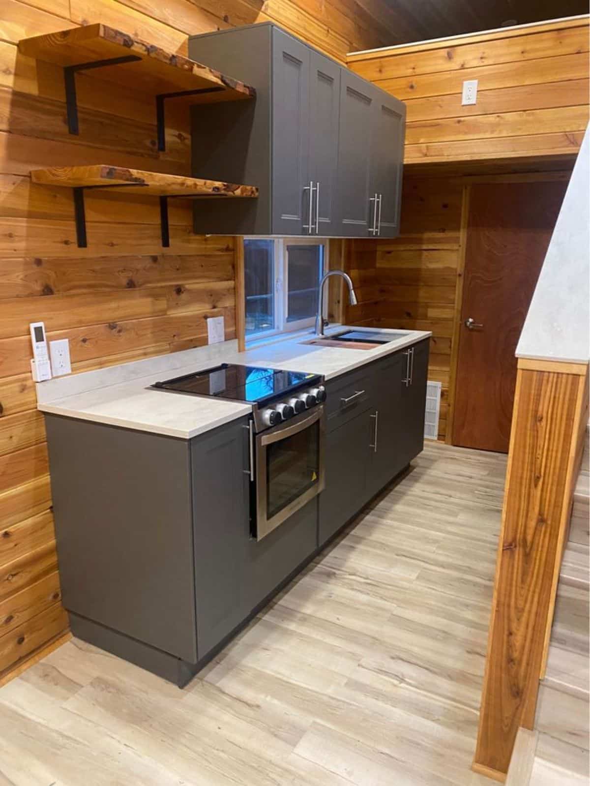stunning and well organized kitchen area of double lofted tiny home