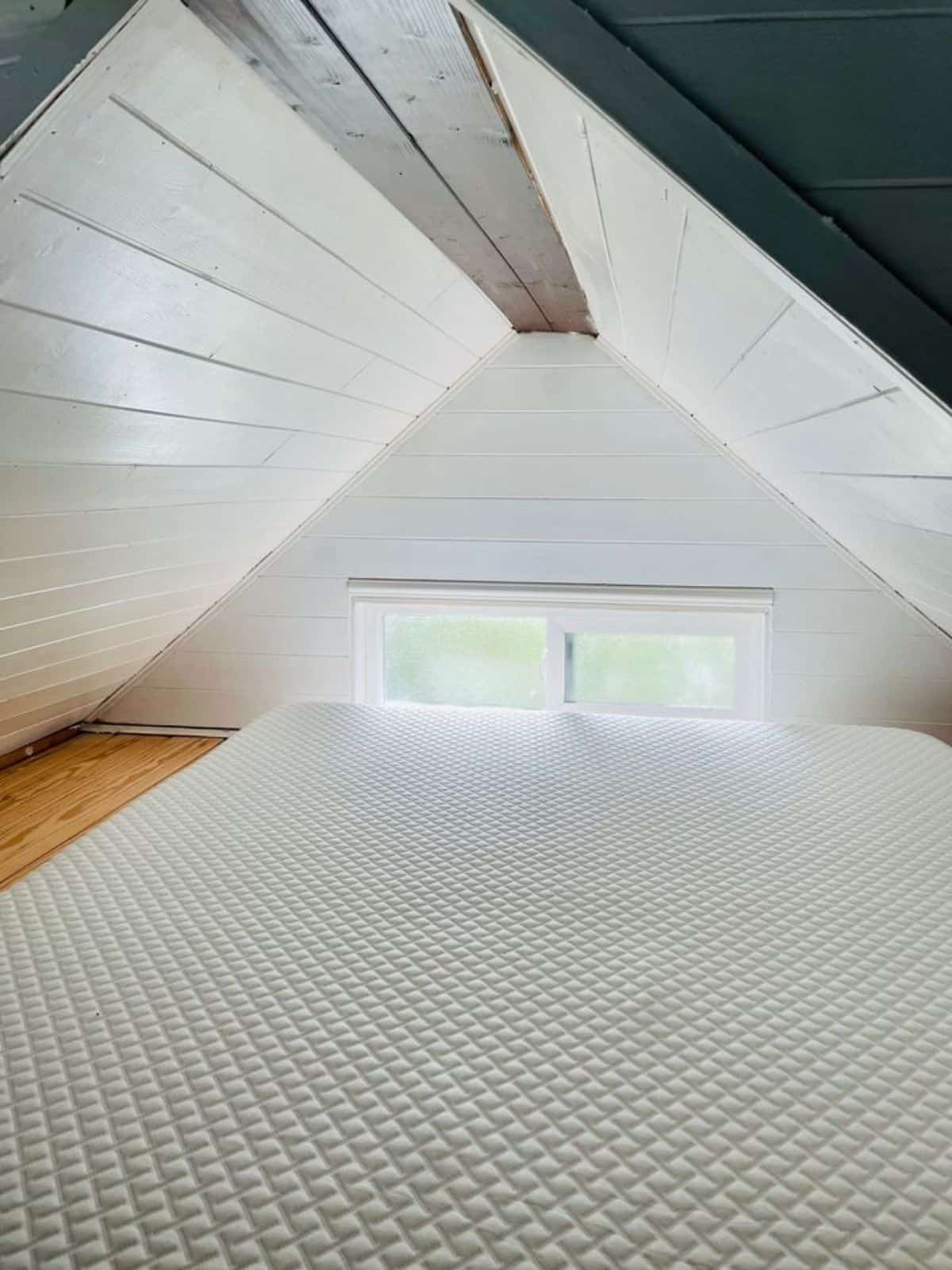 loft bedroom has a comfortable mattress and huge window