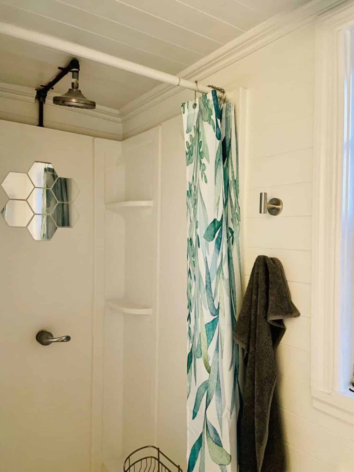full length shower with head shower in bathroom of compact 20’ tiny house