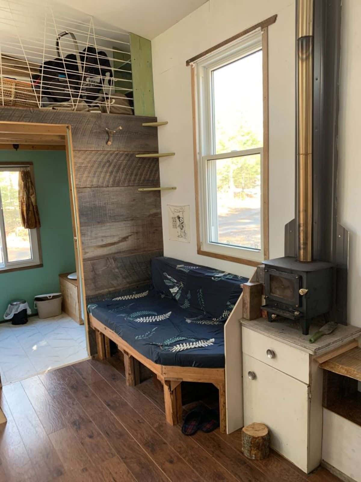 living area of rustic 28’ tiny home has a comfortable couch