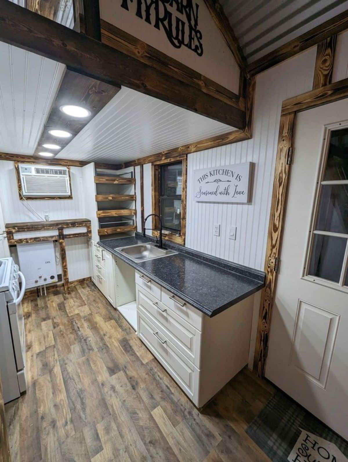 kitchen area of double lofted mobile home has a huge countertop with storage cabinets