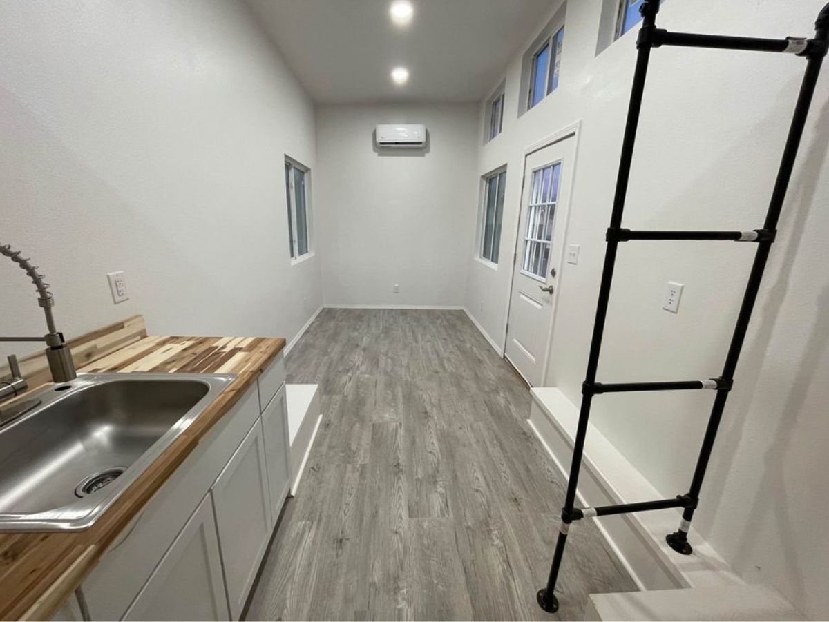 living area of 24’ modern tiny home is huge with air condition unit installed