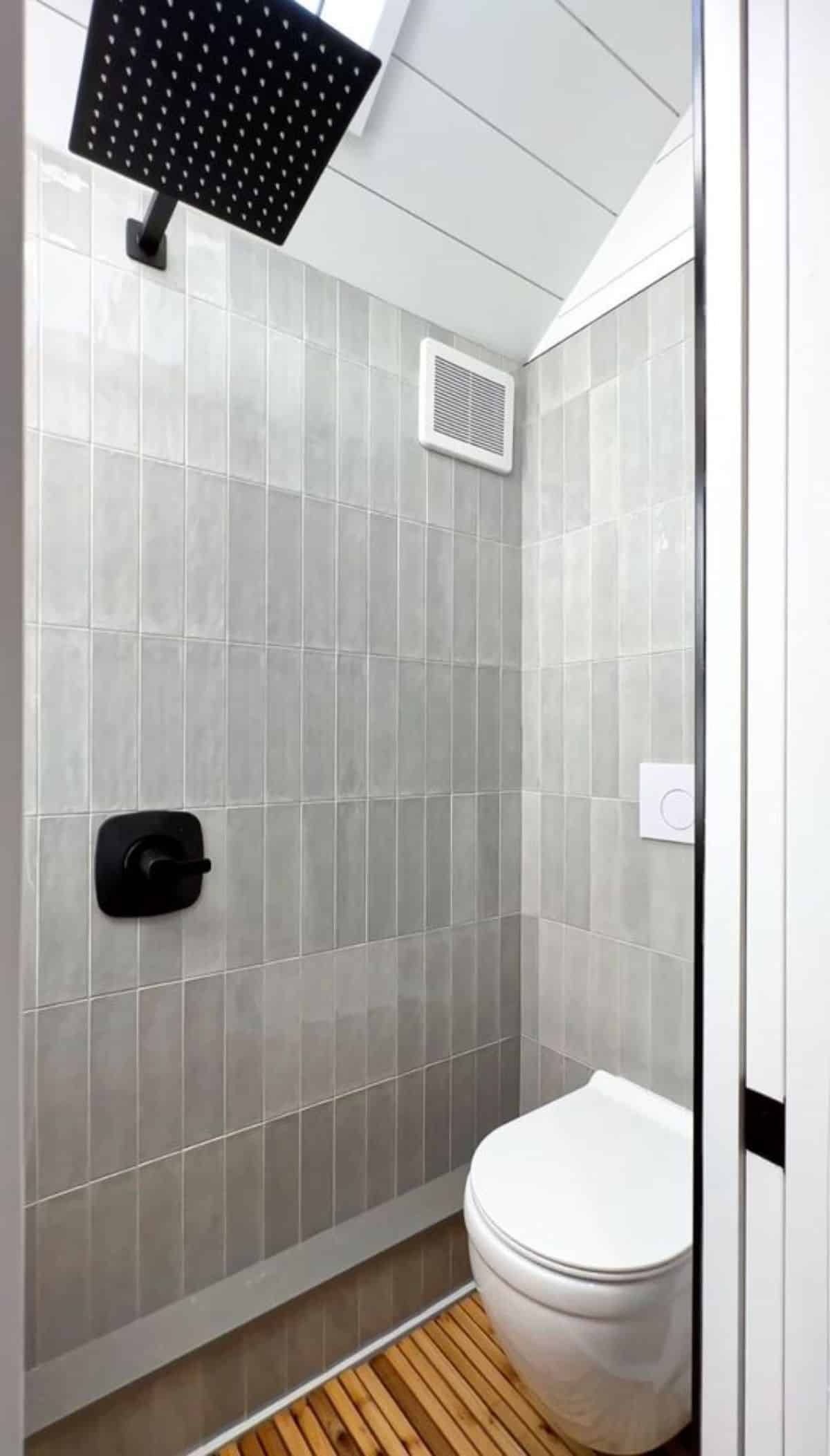standard toilet and head rain shower in bathroom of Jojo Bean