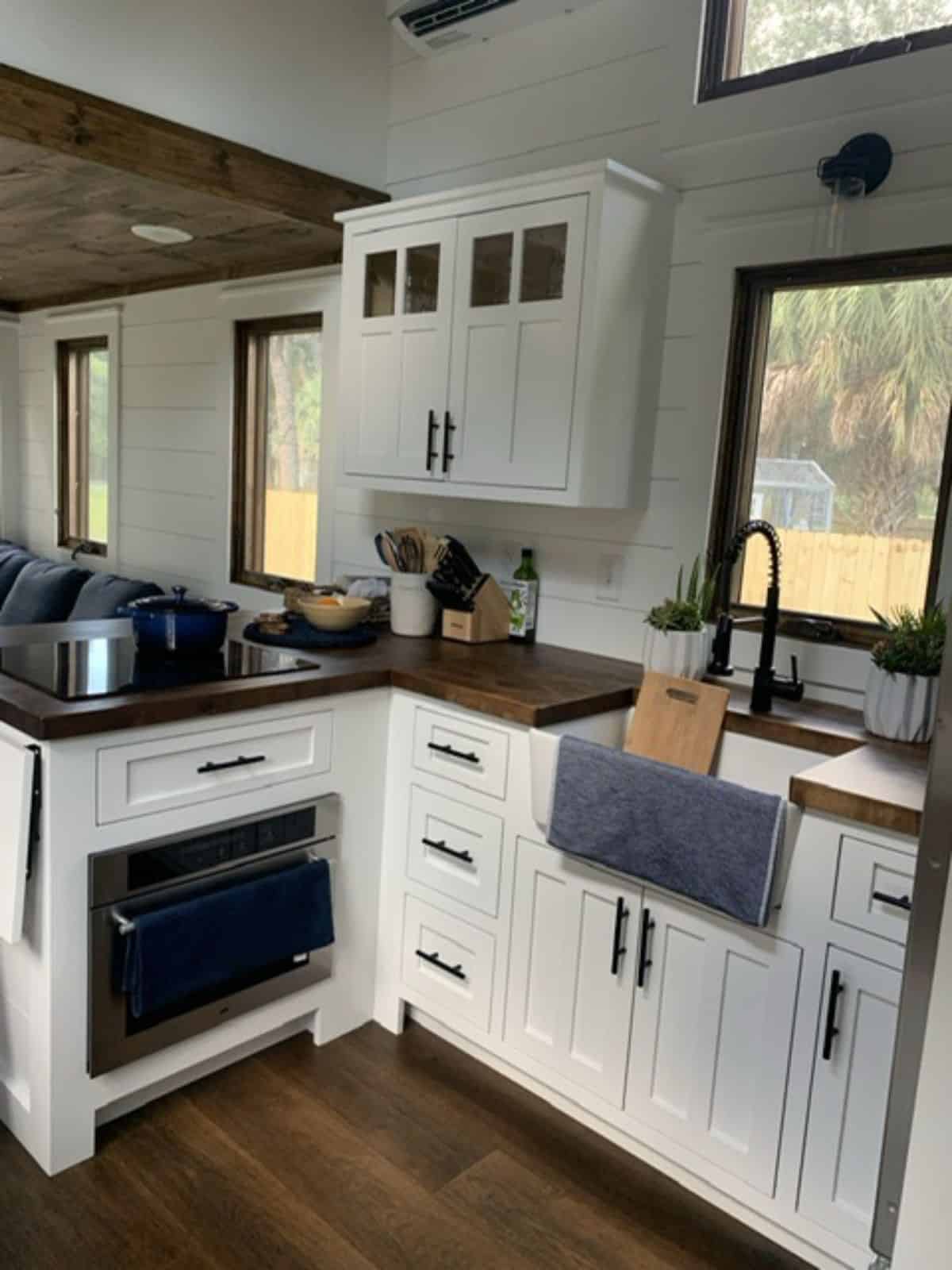L shaped kitchen countertop in kitchen area of gooseneck tiny home