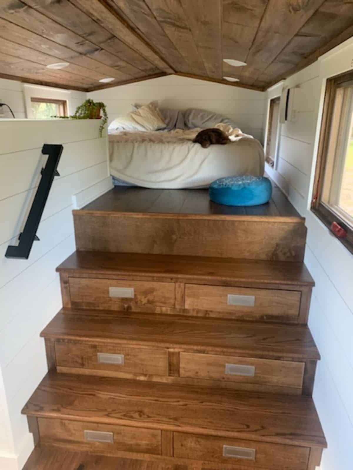 multi purpose stairs leading to the bedroom of gooseneck tiny home