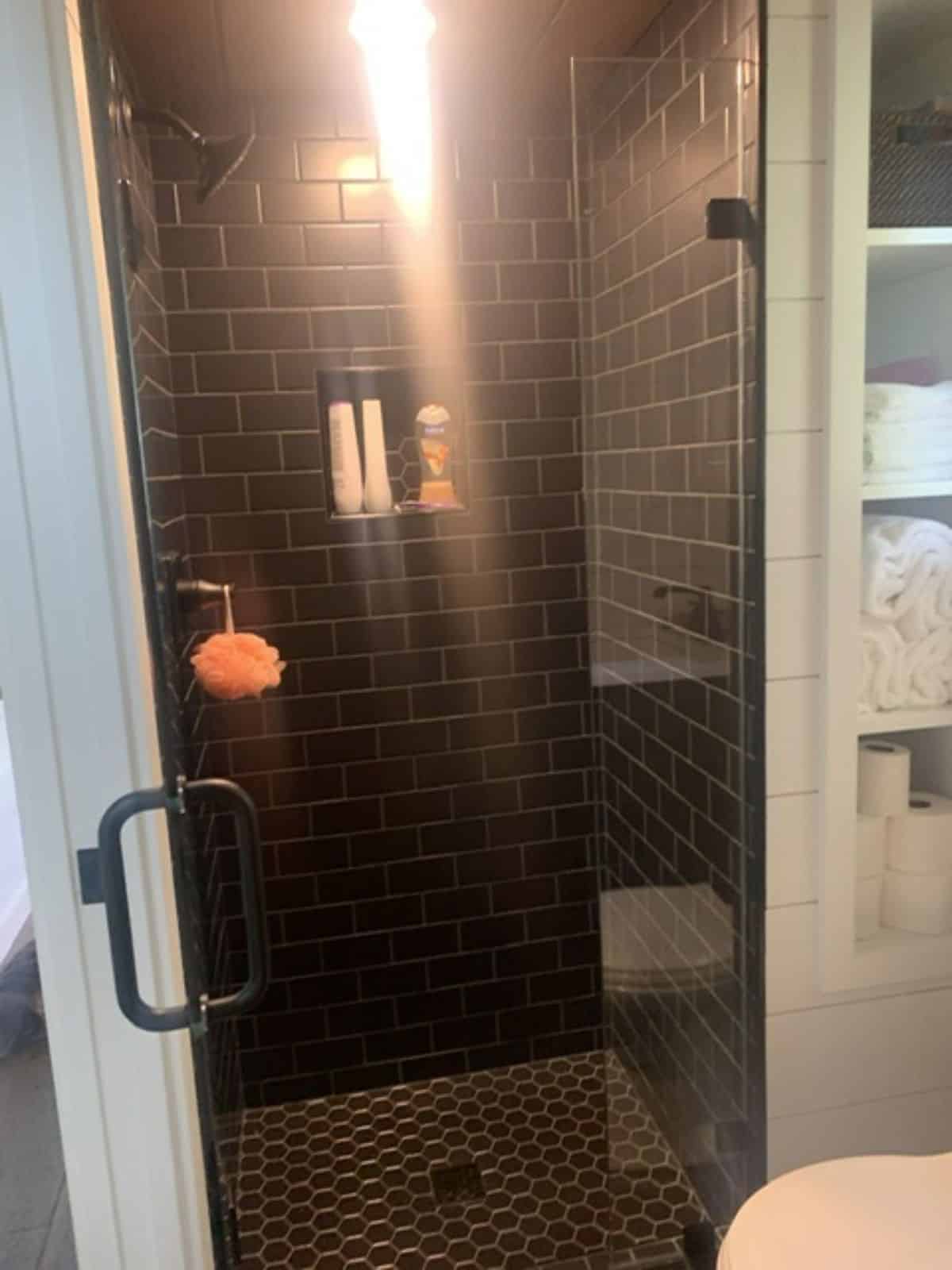 full length tiled shower area with glass enclosure