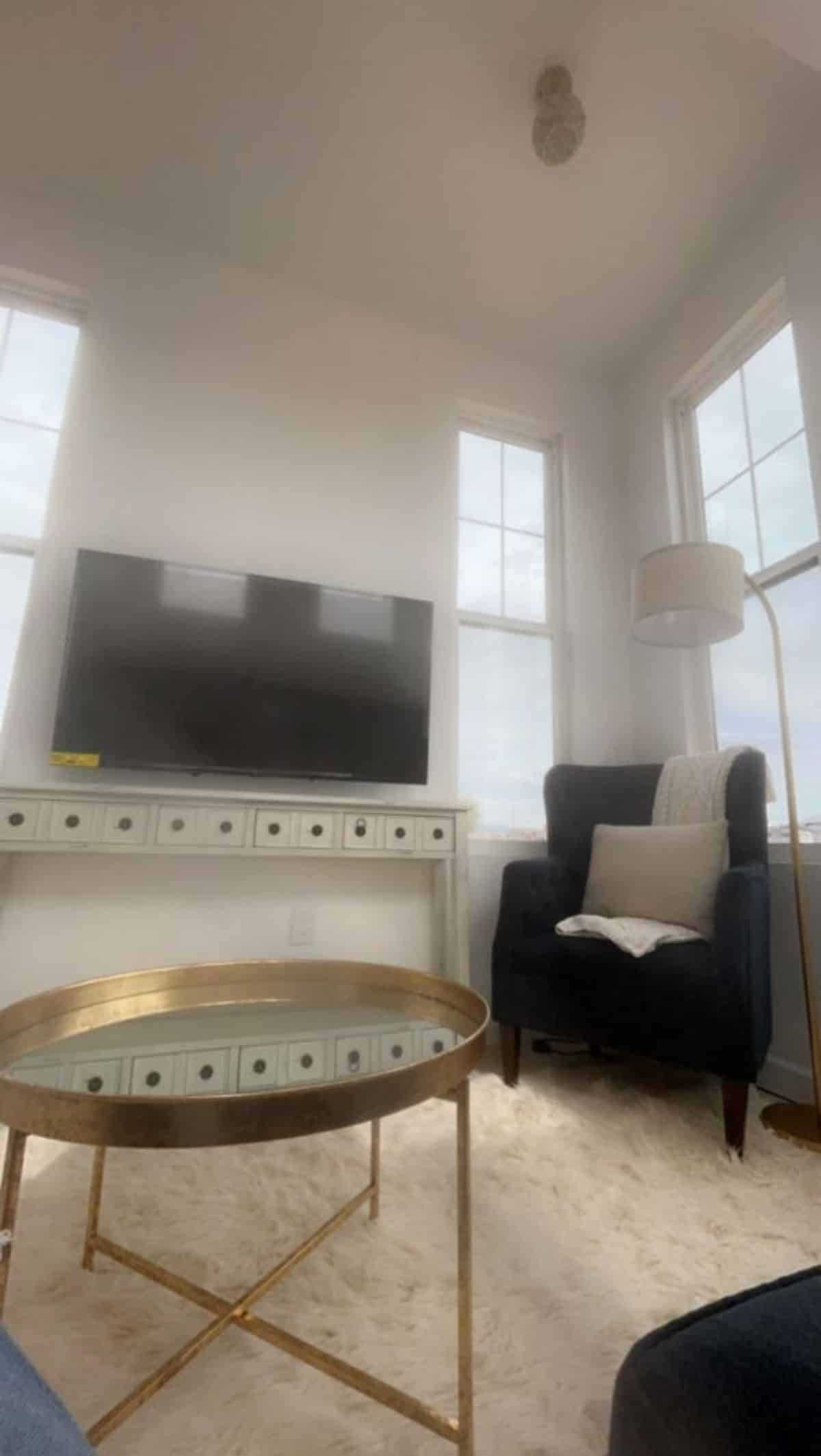 wall mounted TV set with center table in living area