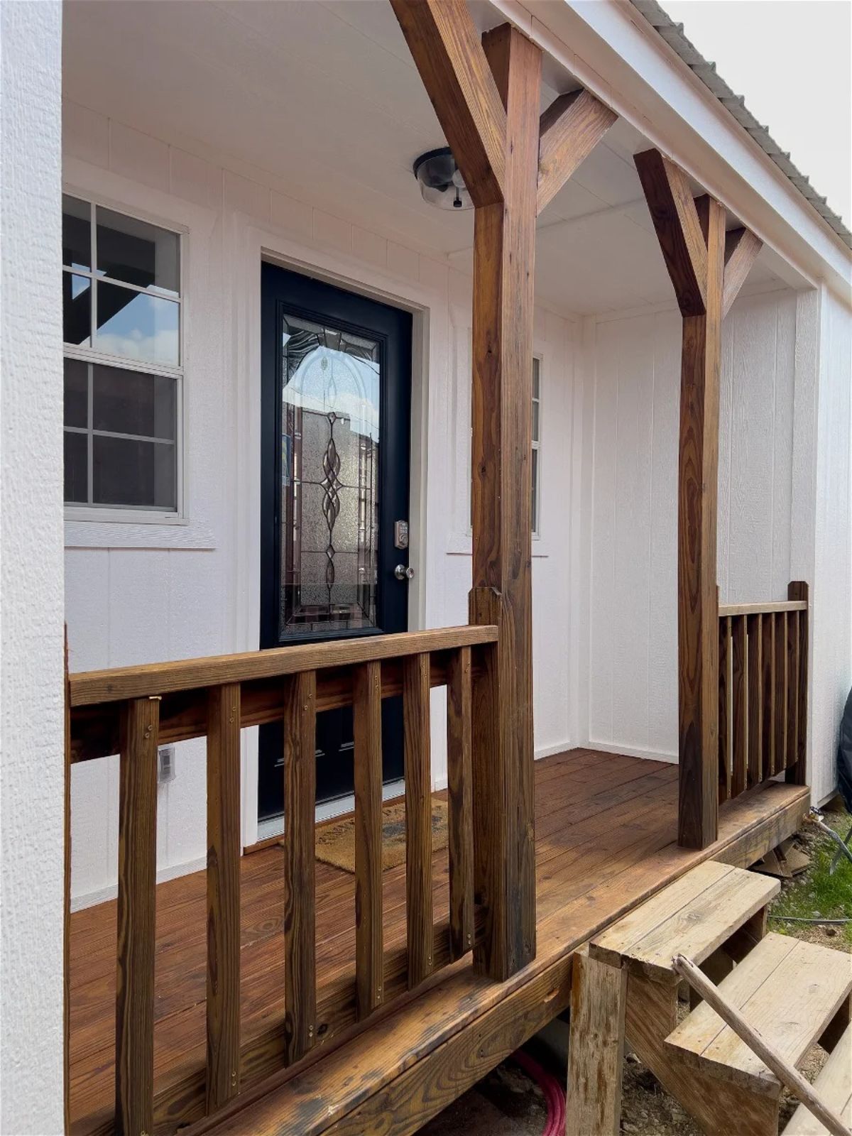 stunning porch outside the main entrance of super spacious tiny house