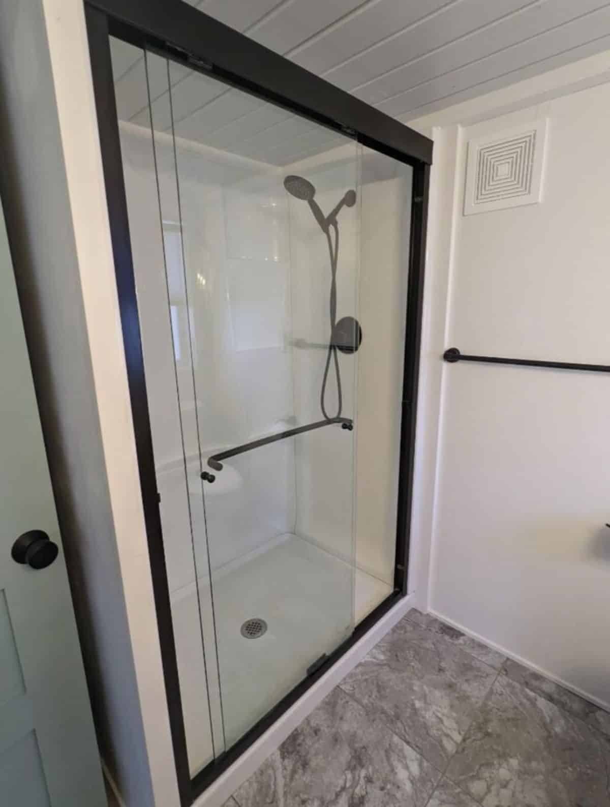 separate shower area with head shower and glass enclosure