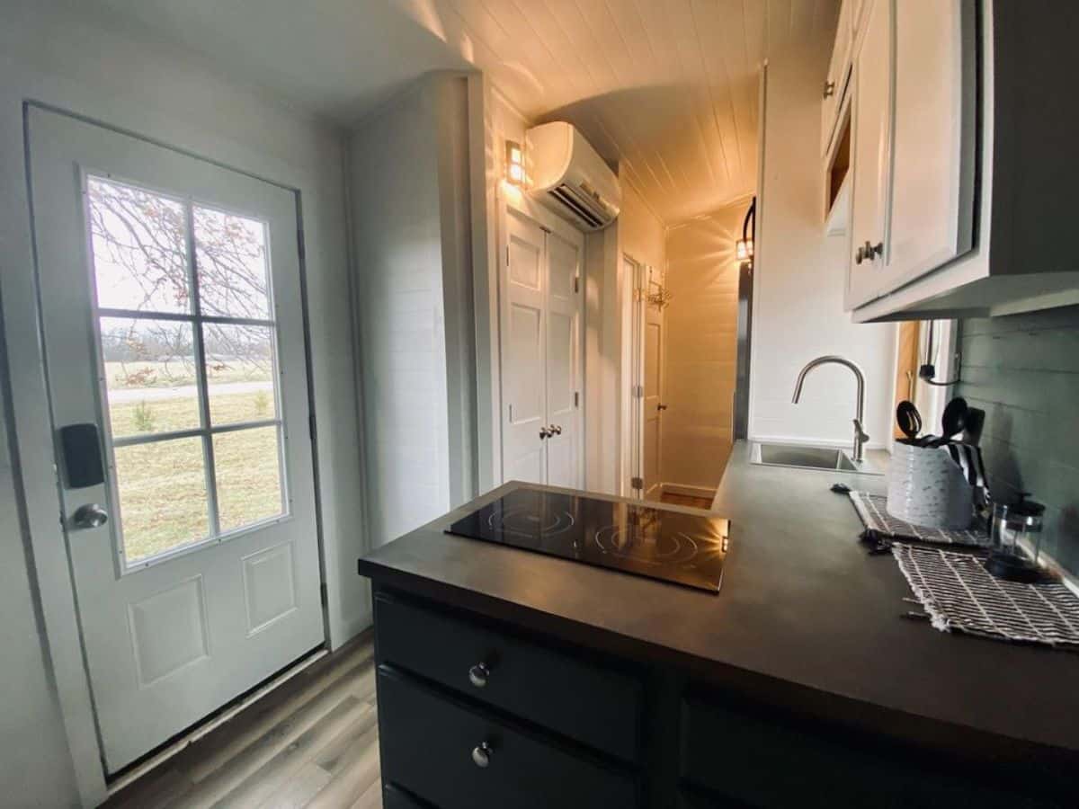 L shaped kitchen area has a stove, sink etc