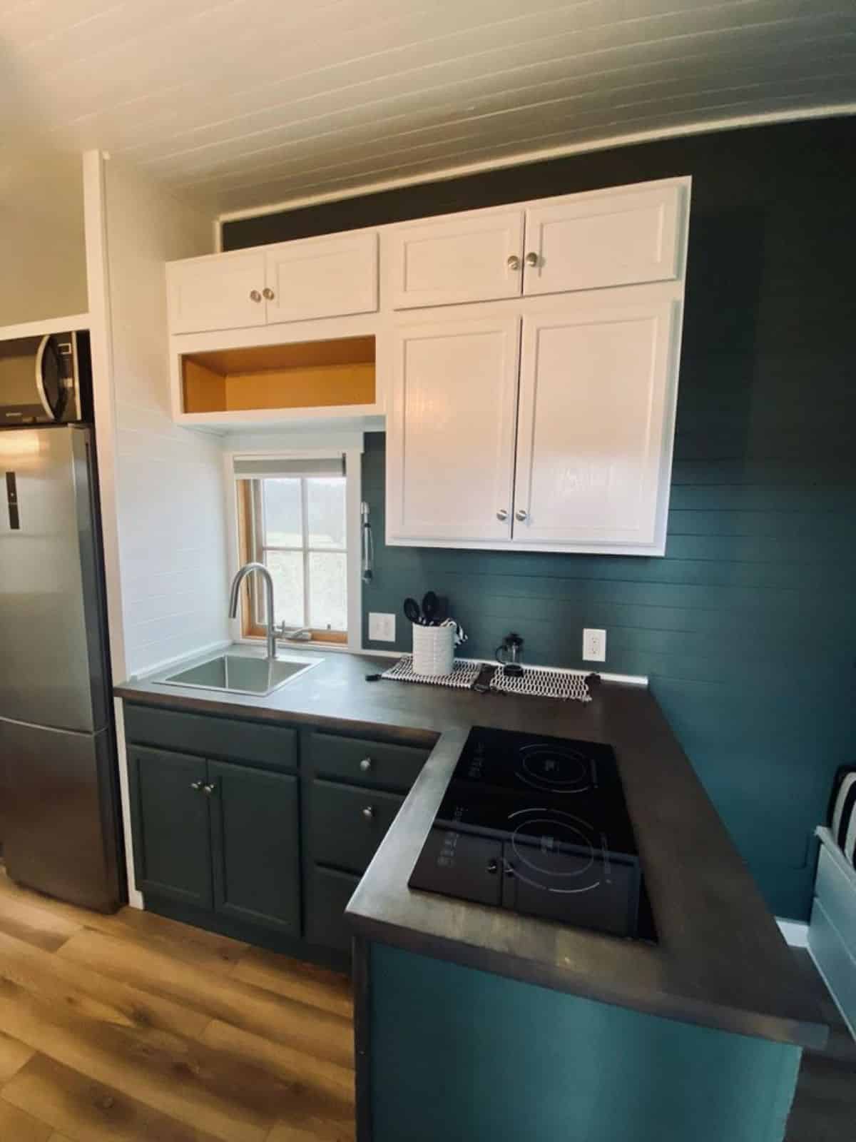 L shaped kitchen countertop with storage in kitchen of Tumbleweed tiny home