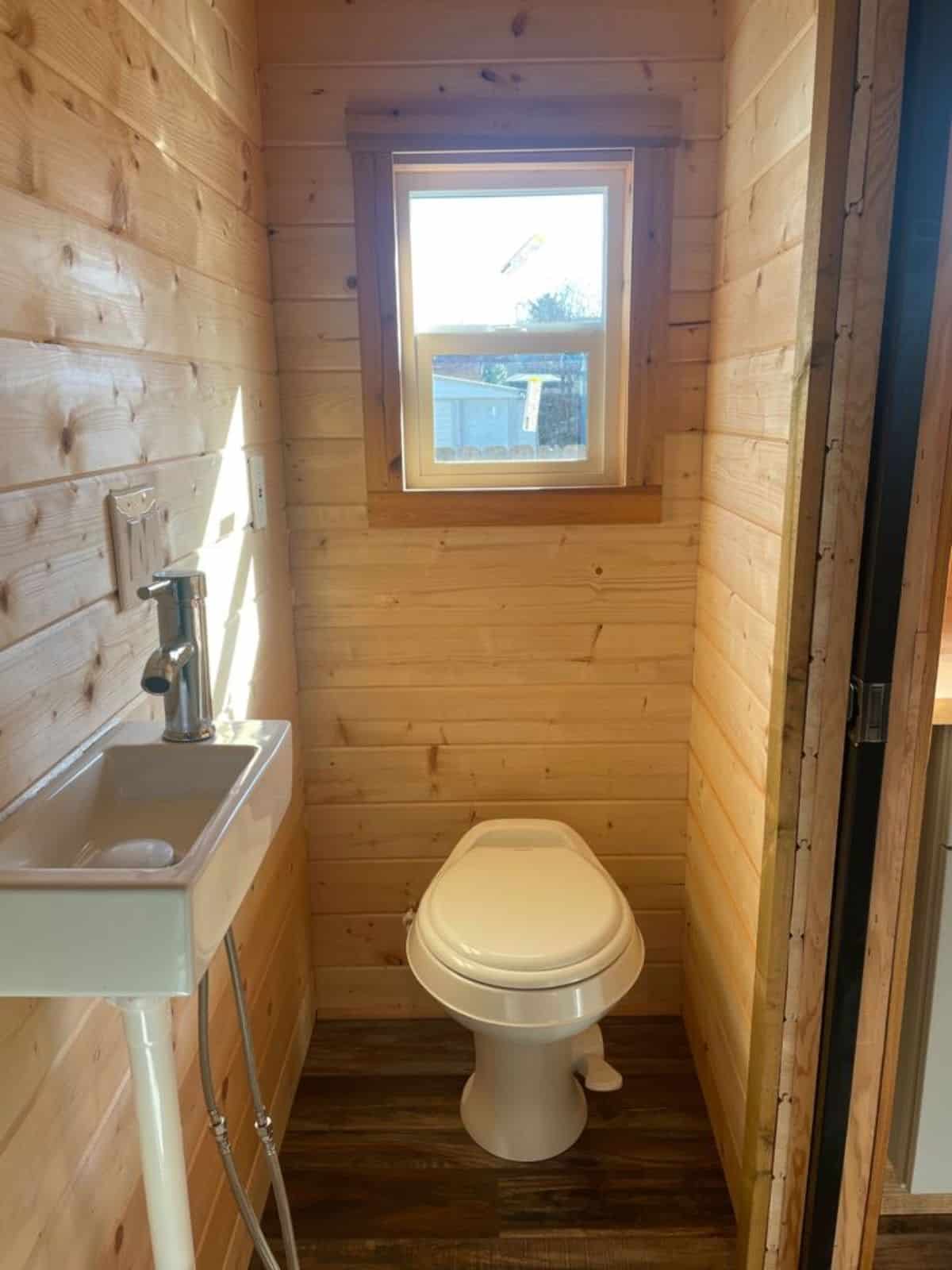 standard toilet, sink and separate shower area in bathroom