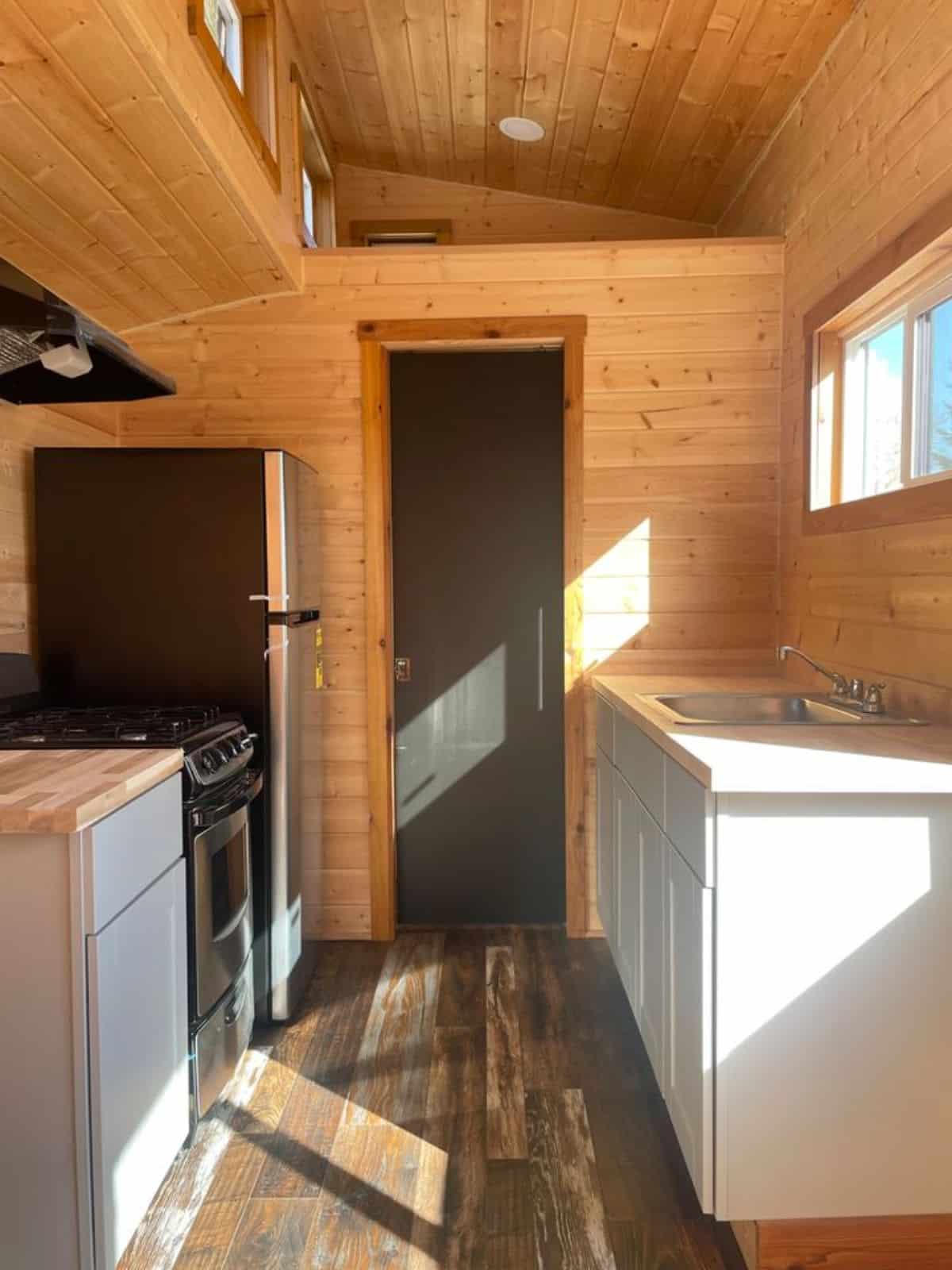 small living area and double galley kitchen area with another loft view of 20' tiny trailer house