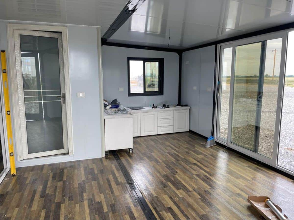 L shaped kitchen area of expandable tiny home