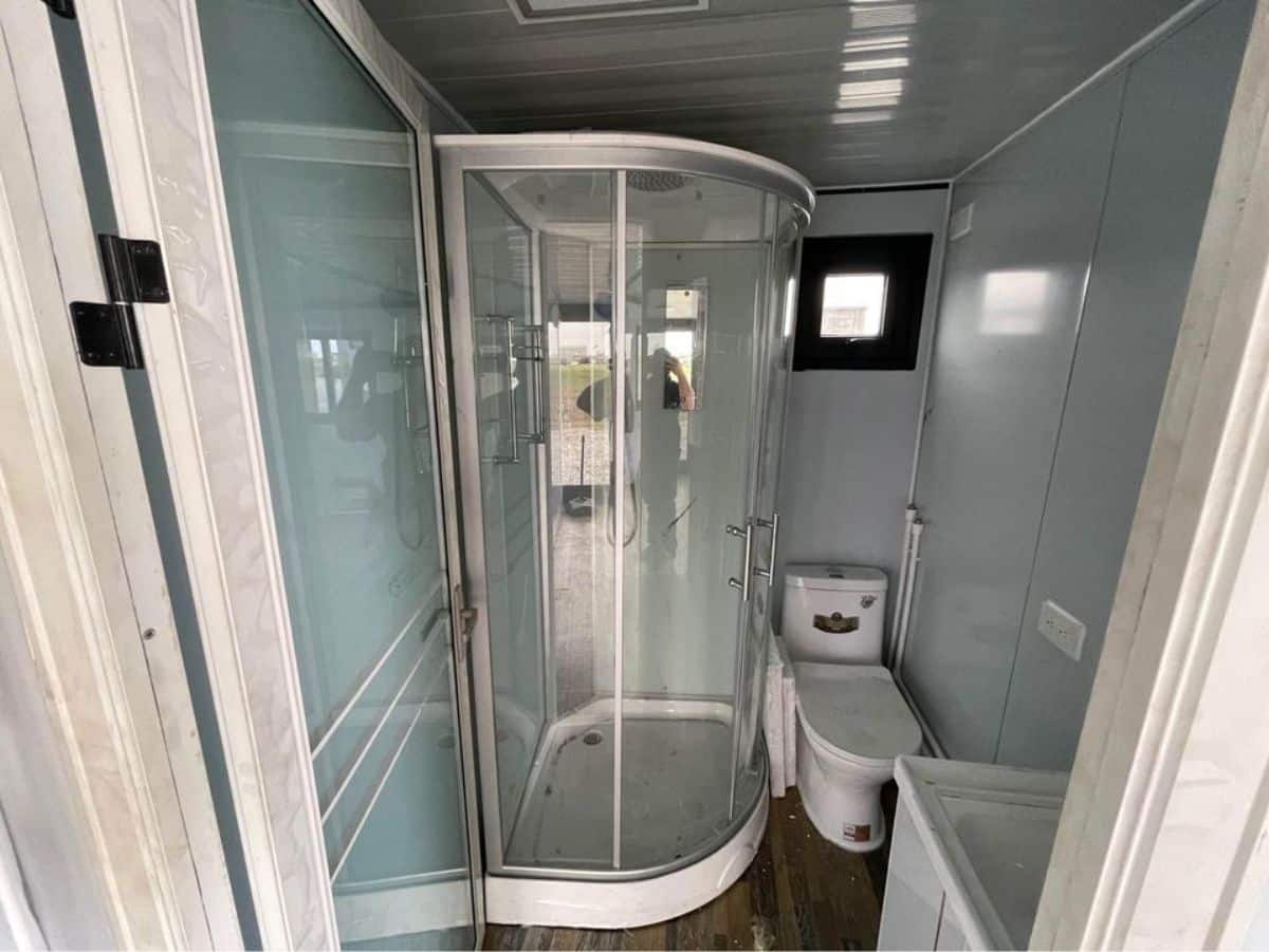 full length shower area with glass enclosure in bathroom