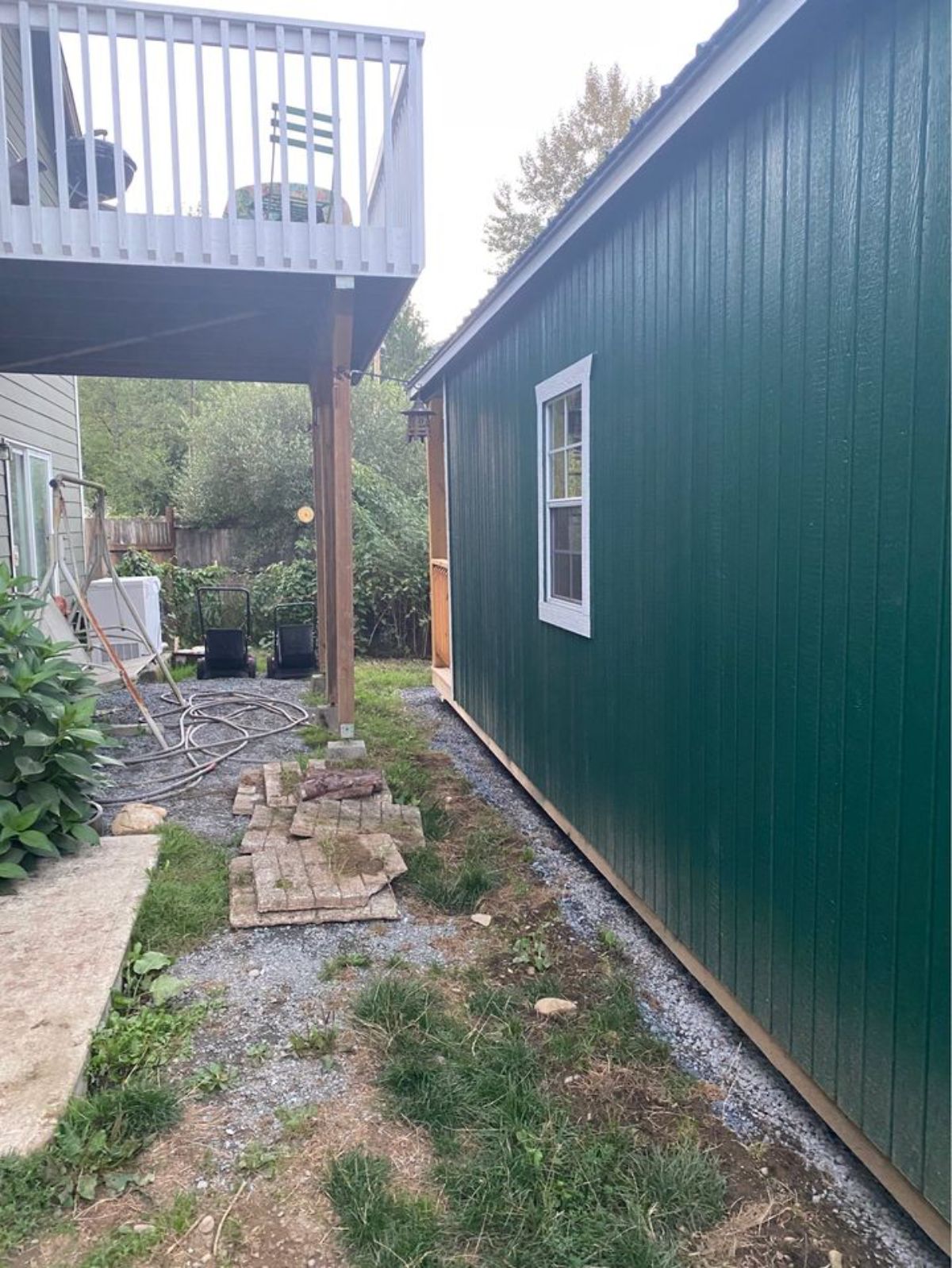 huge green and white exterior of portable cabin home from side view