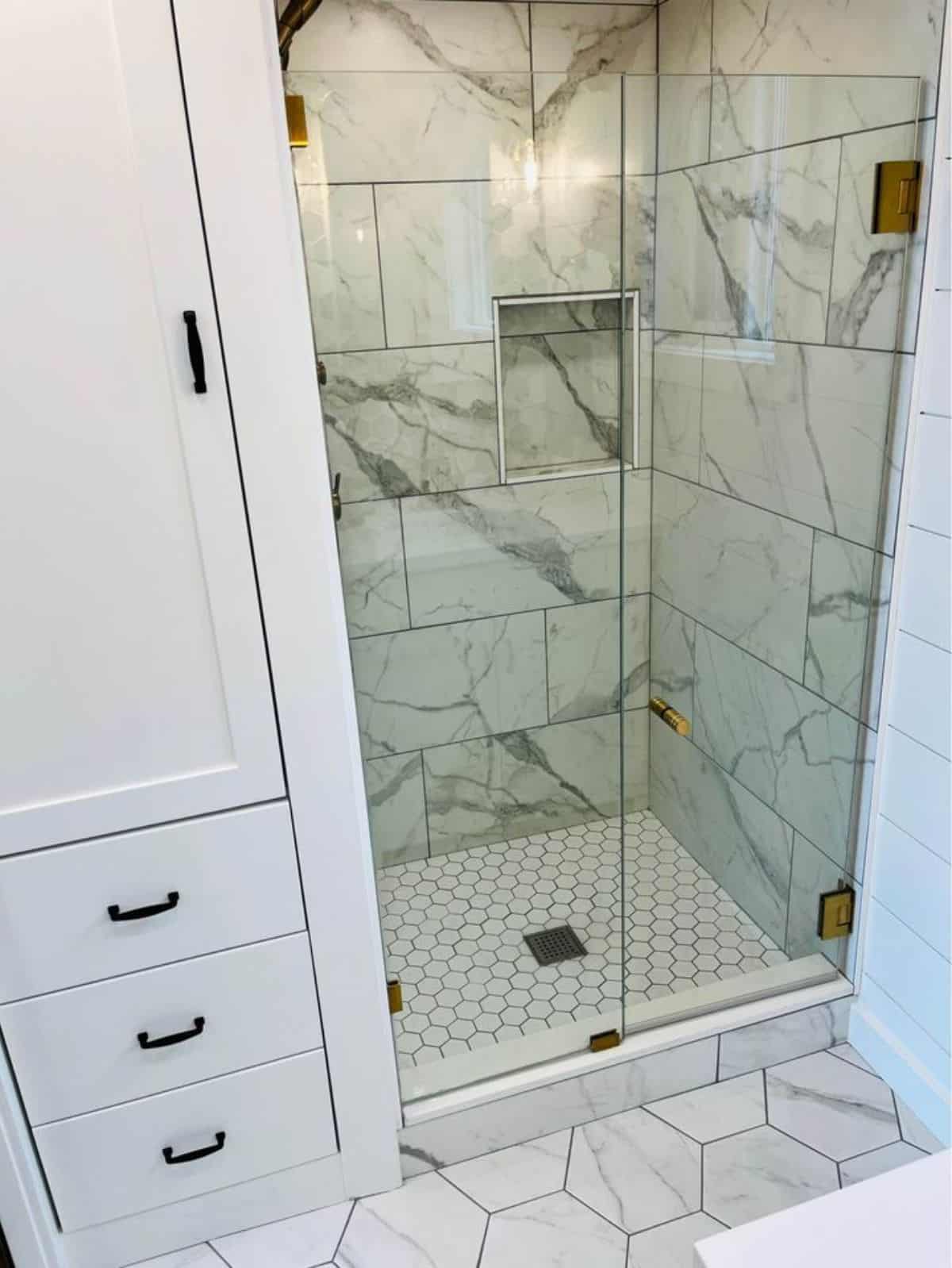 full length shower area in bathroom of one bedroom custom home