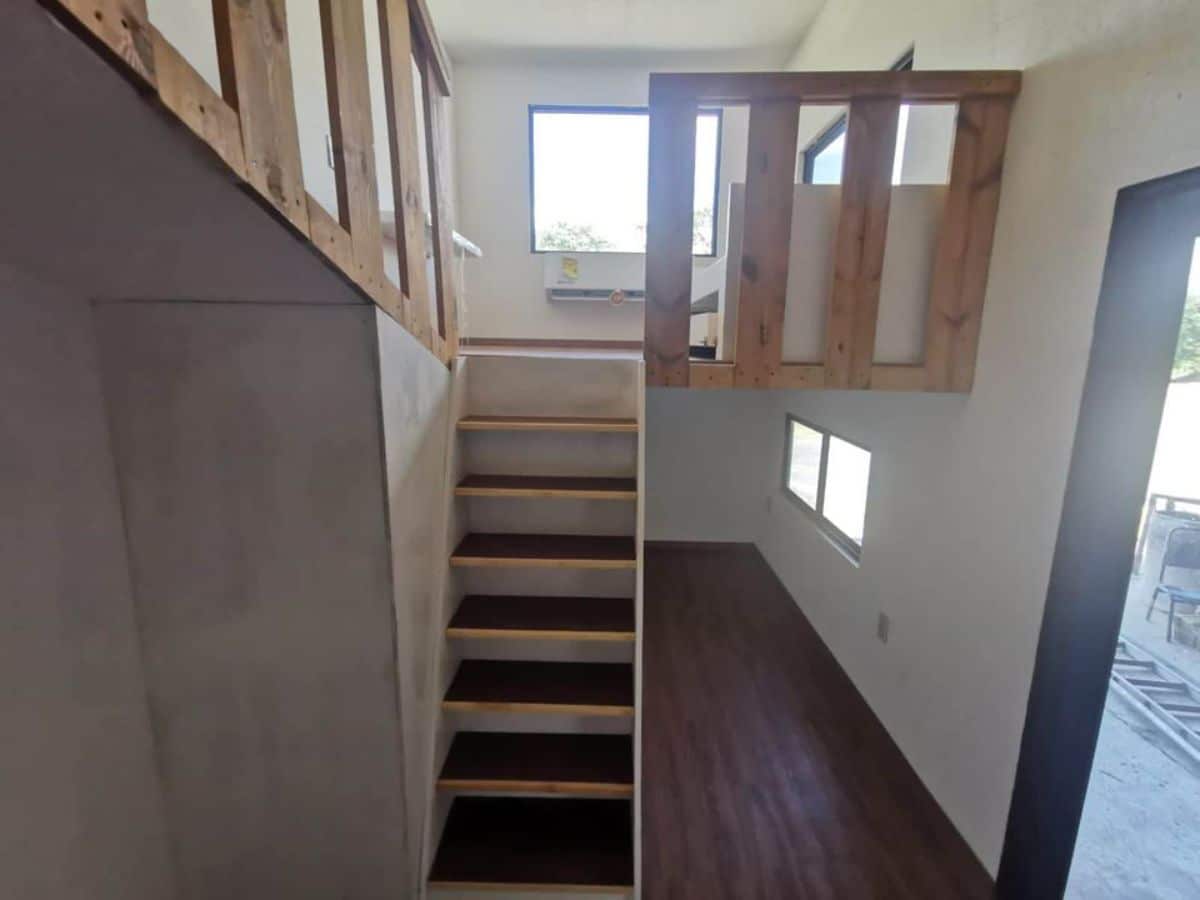 stairs leading to the 2 inter connected lofts of double lofted home