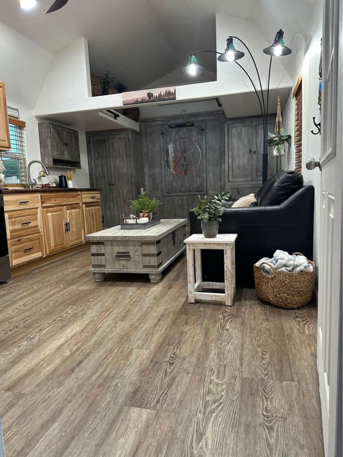 wooden flooring and living area of 32’ tiny house