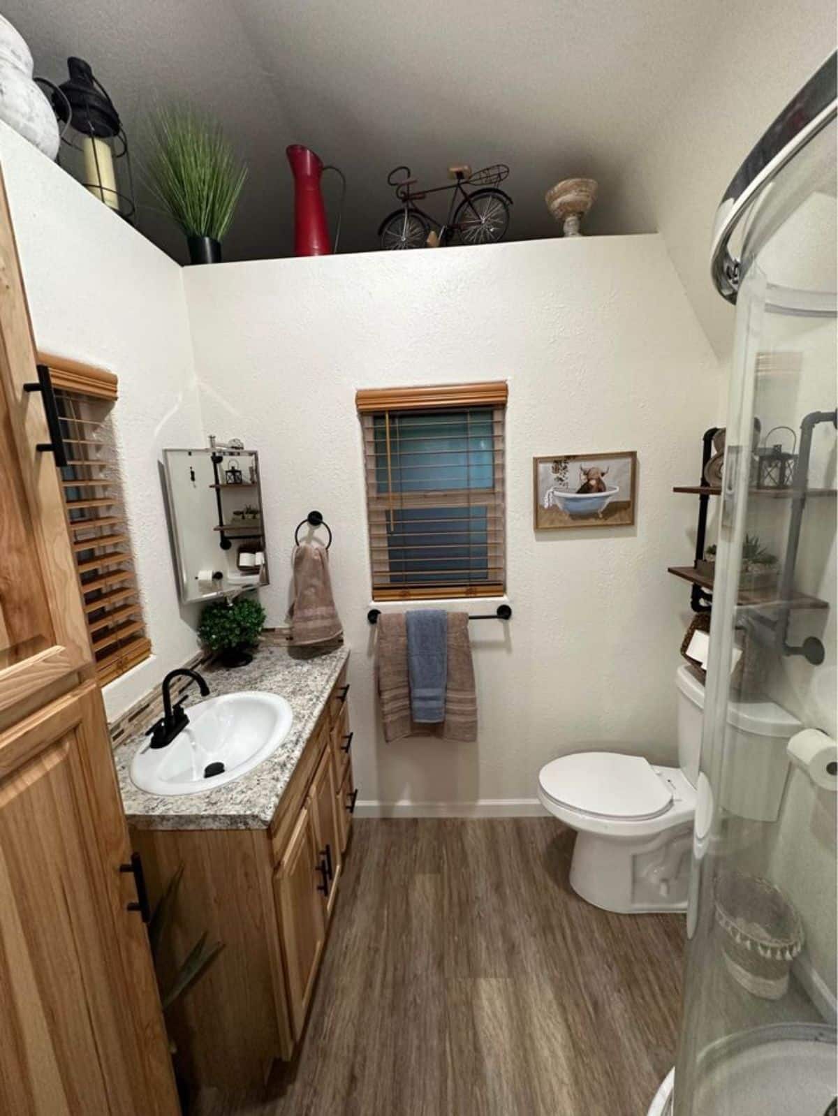 bathroom of 32’ tiny house has all the standard fittings with separate shower with glass enclosure