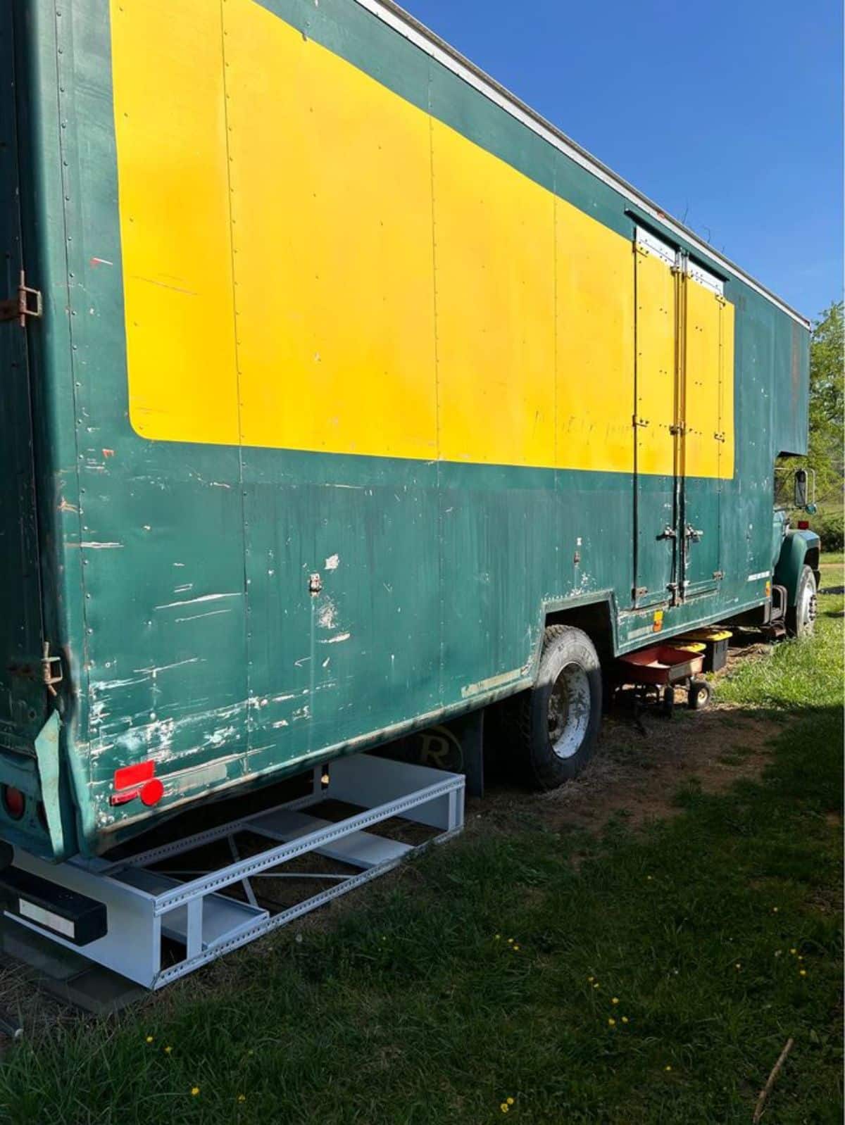green and yellow exterior walls of drivable tiny home
