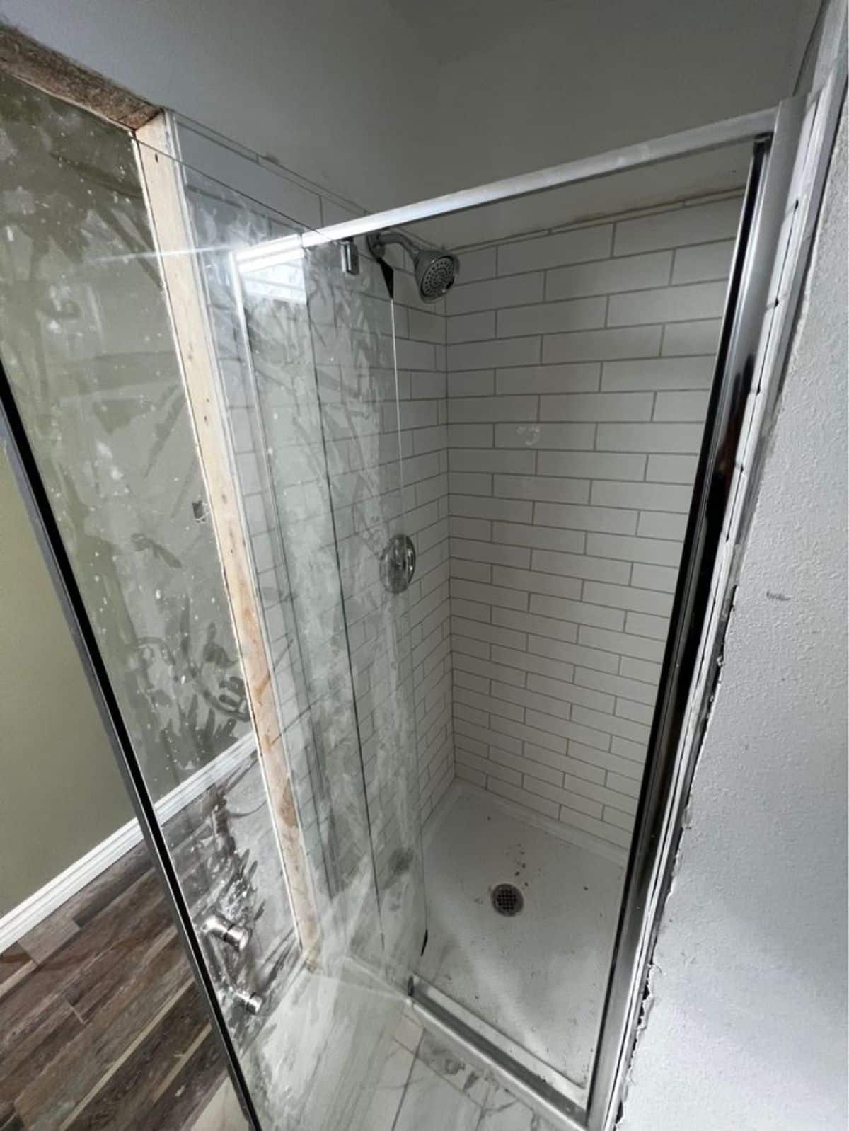 separate shower area with rain shower and glass door in bathroom