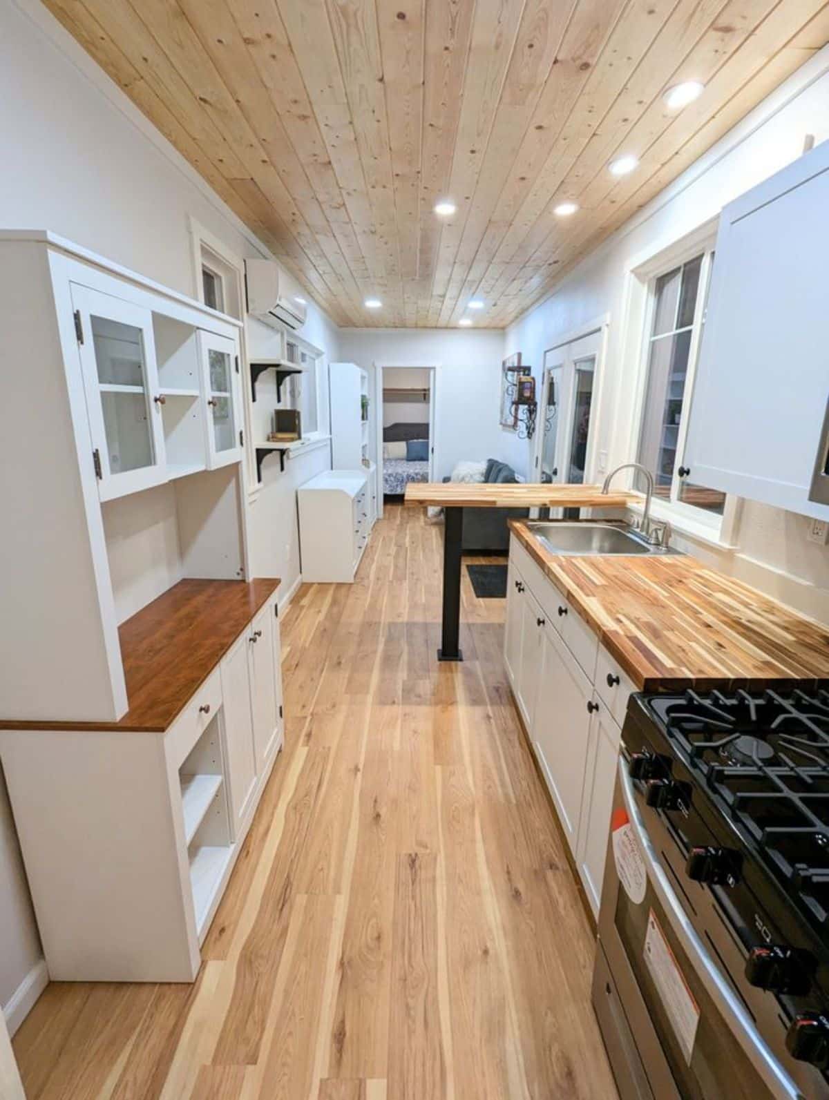 full length view of wooden interiors of 40’ custom tiny home