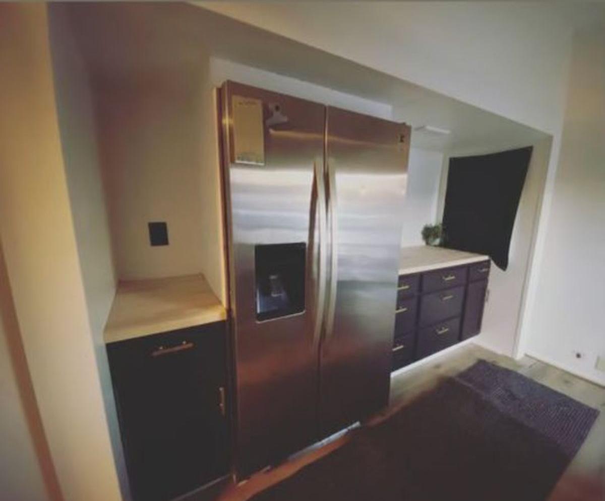 double door huge refrigerator opposite to the kitchen area