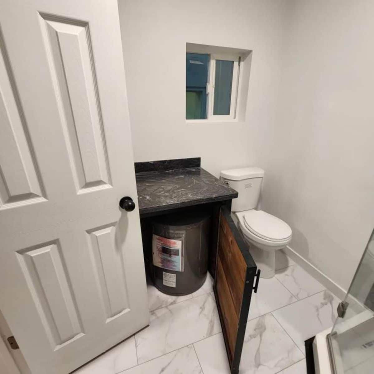 ample space and storage under the sink  in bathroom of beautiful container home