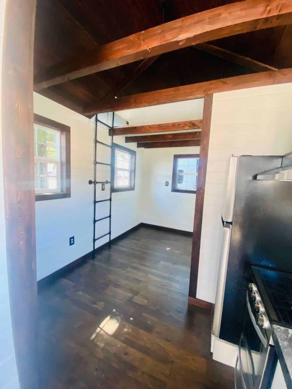 wooden flooring and multiple windows of brand new tiny house