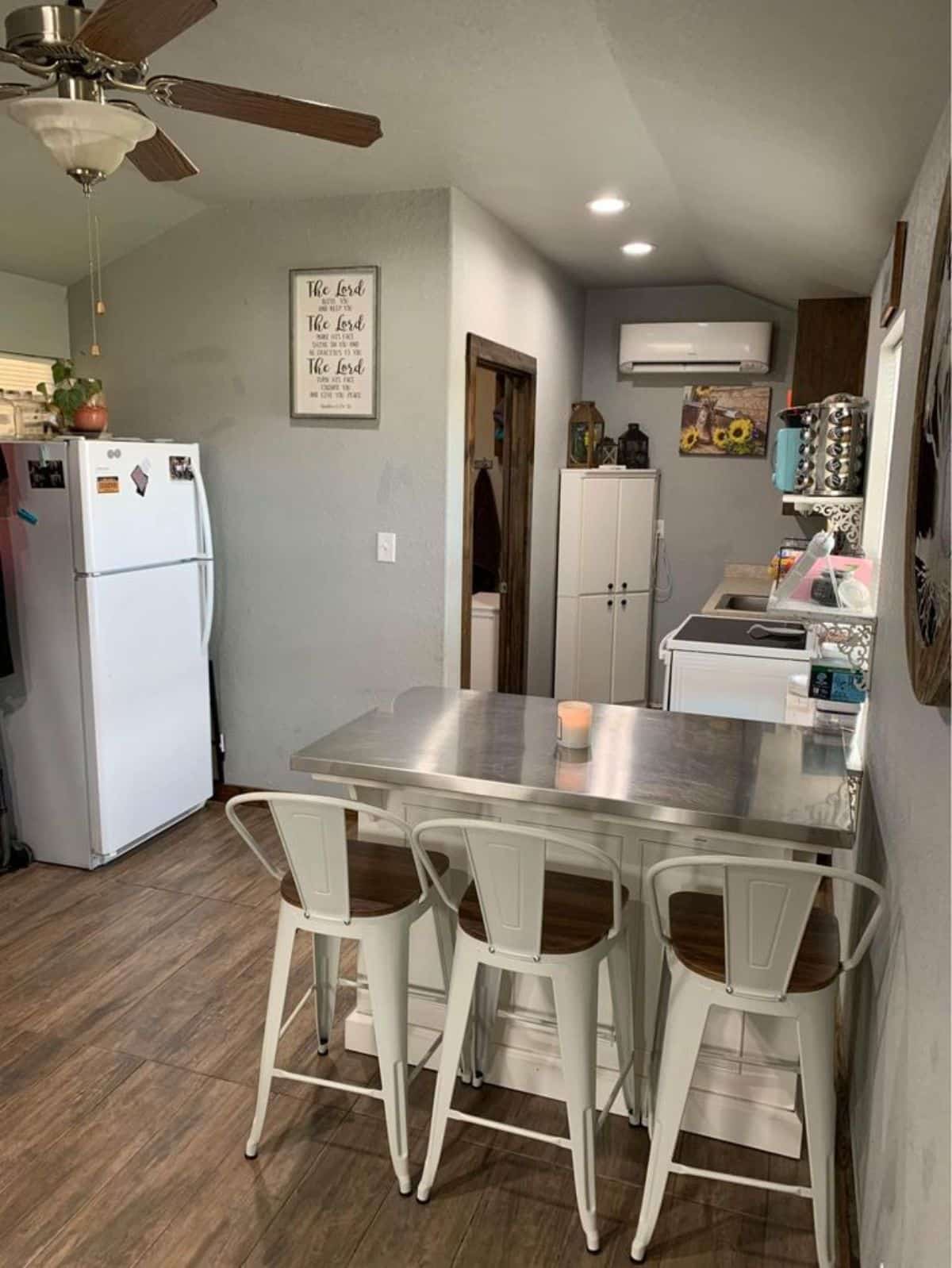 3 chair dining table in between living and kitchen area