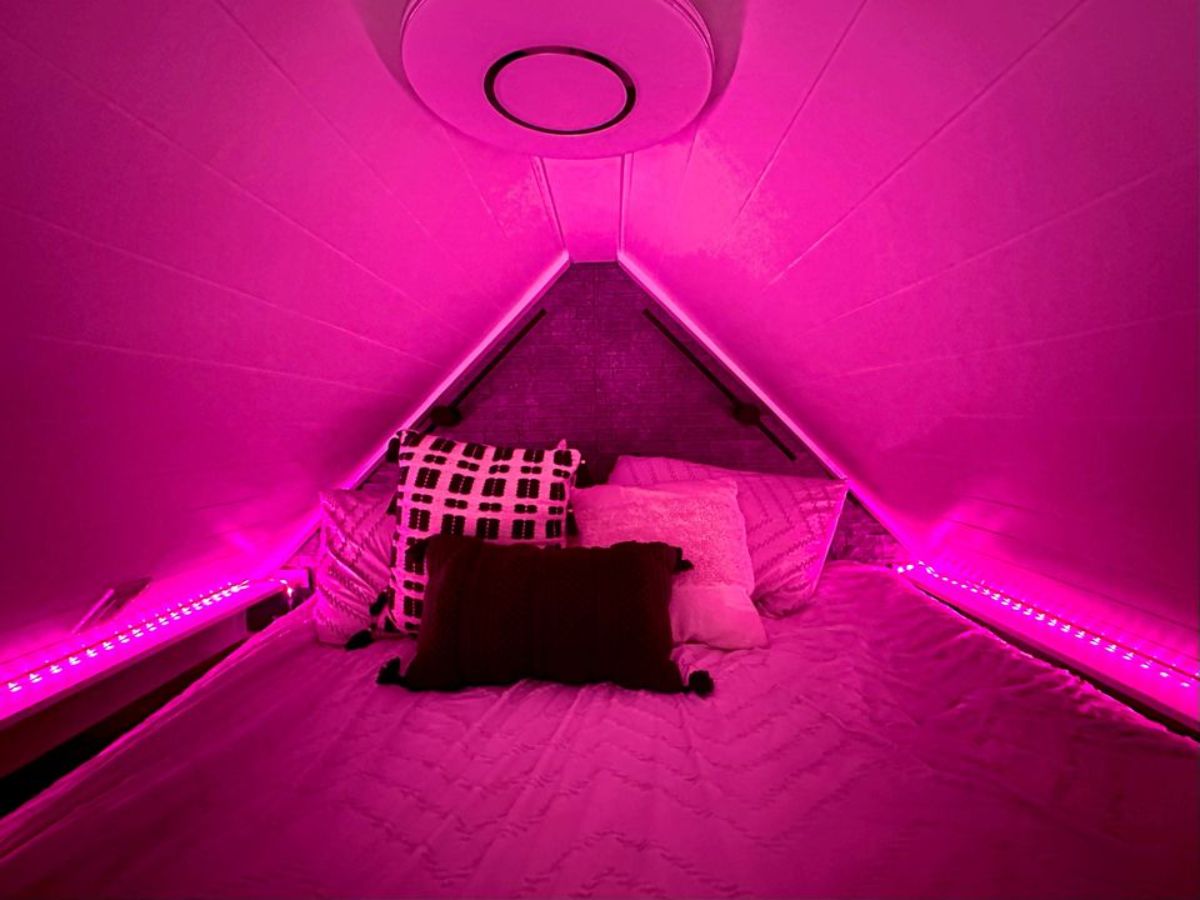 multiple colored LED lights installed to give a romantic vibe on loft of furnished micro home