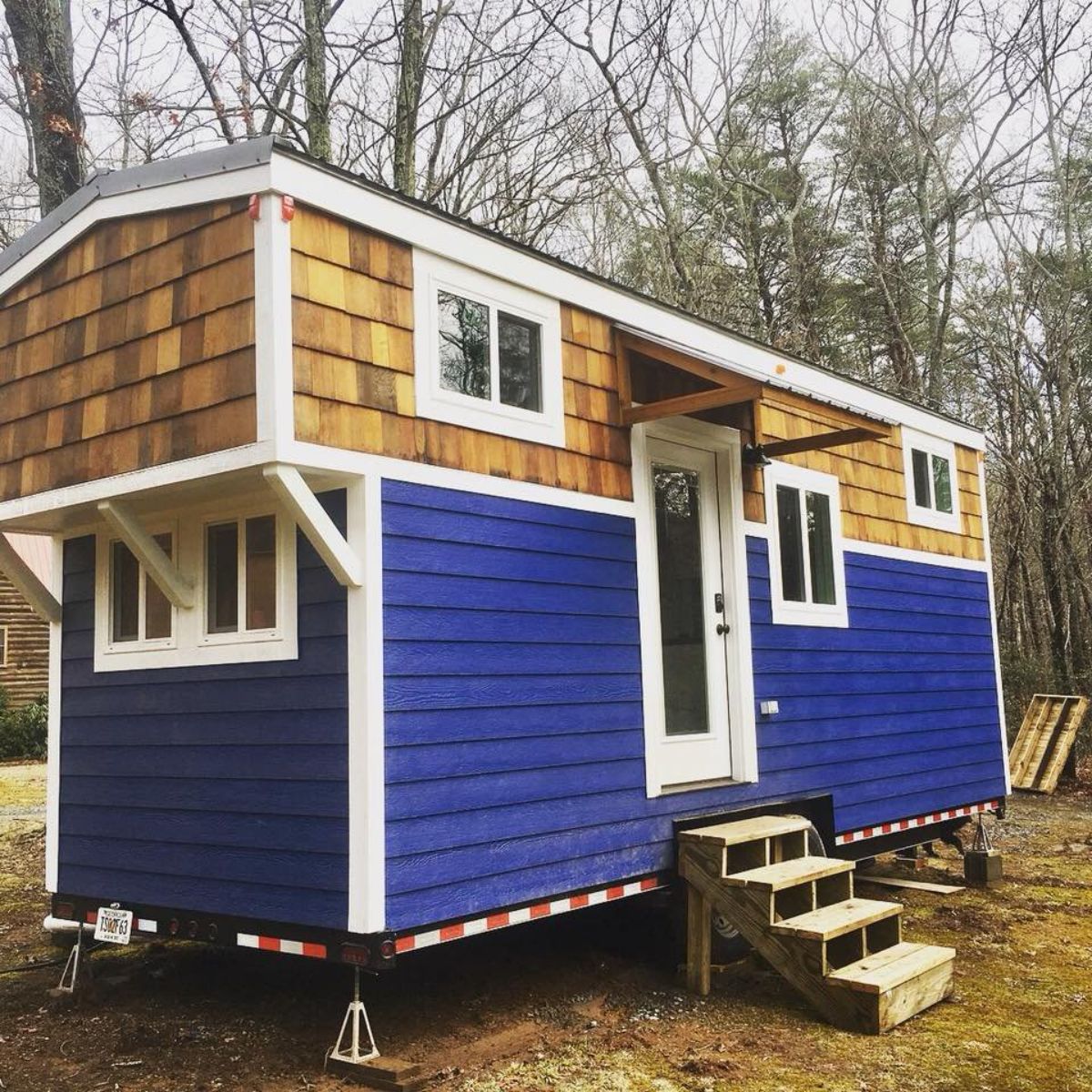main entrance and stunning blue and brown exterior of Noah certified tiny house
