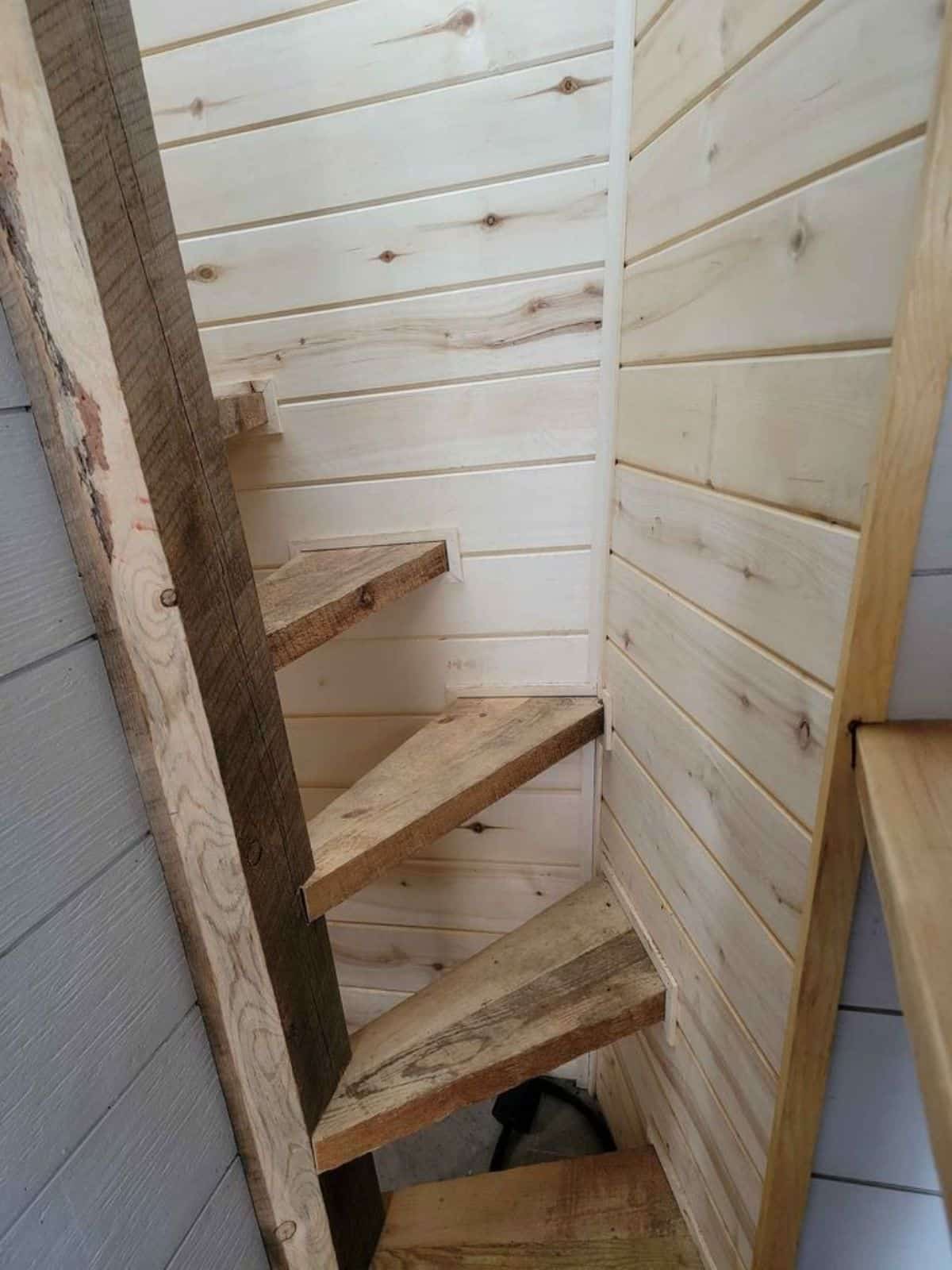 customized stairs leading to the loft of 1 bedroom tiny house