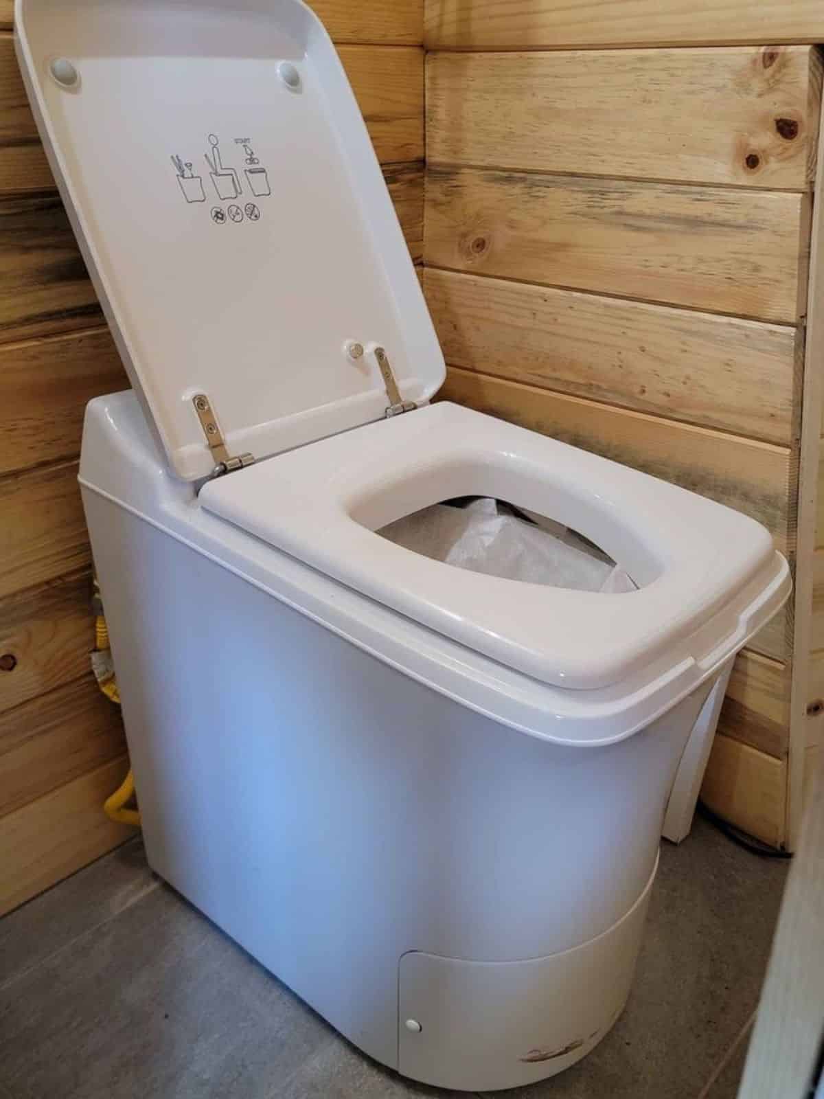 propane powered incinerator toilet installed in bathroom of 1 bedroom tiny house