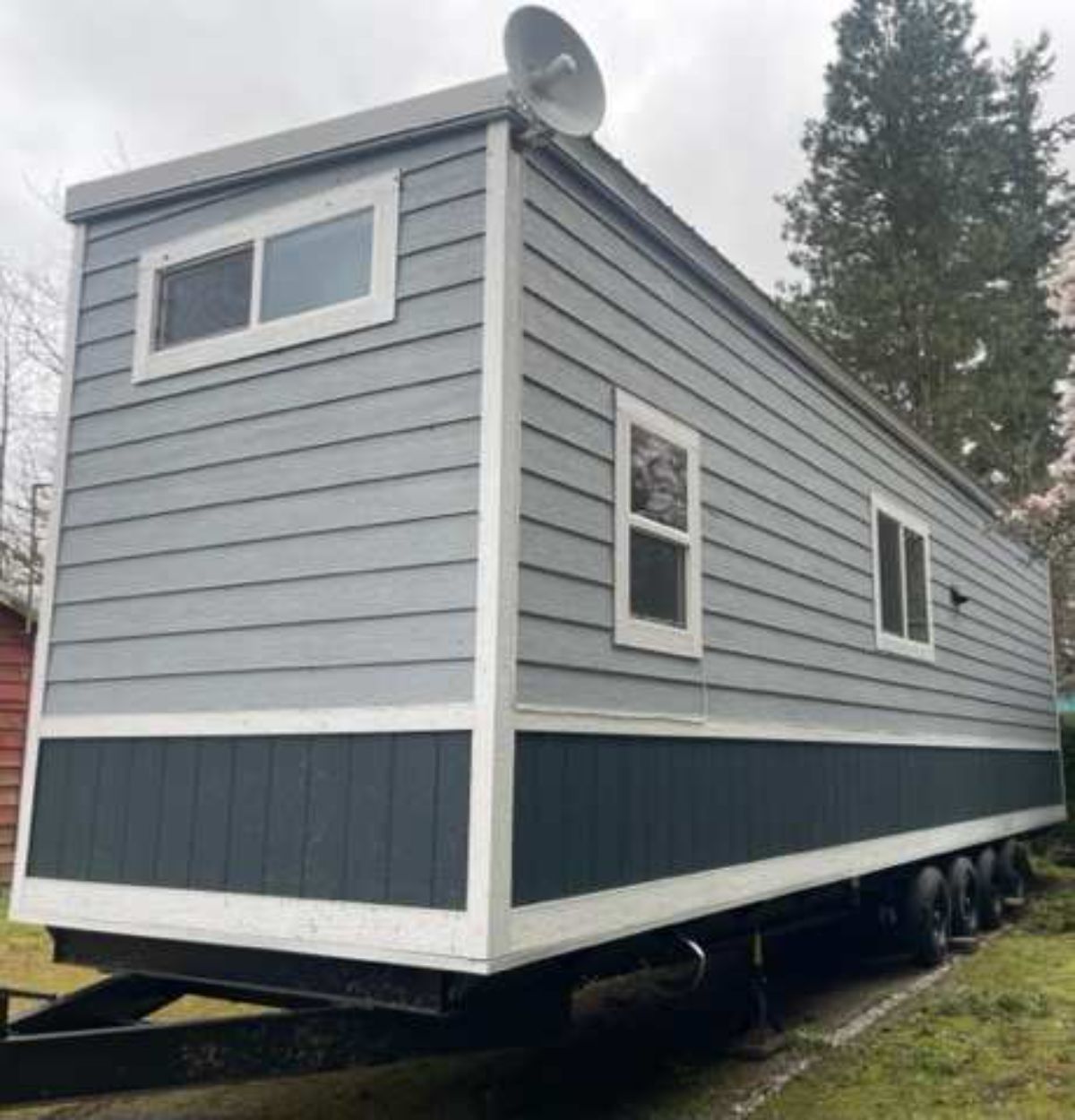 backside of tiny home with a loft