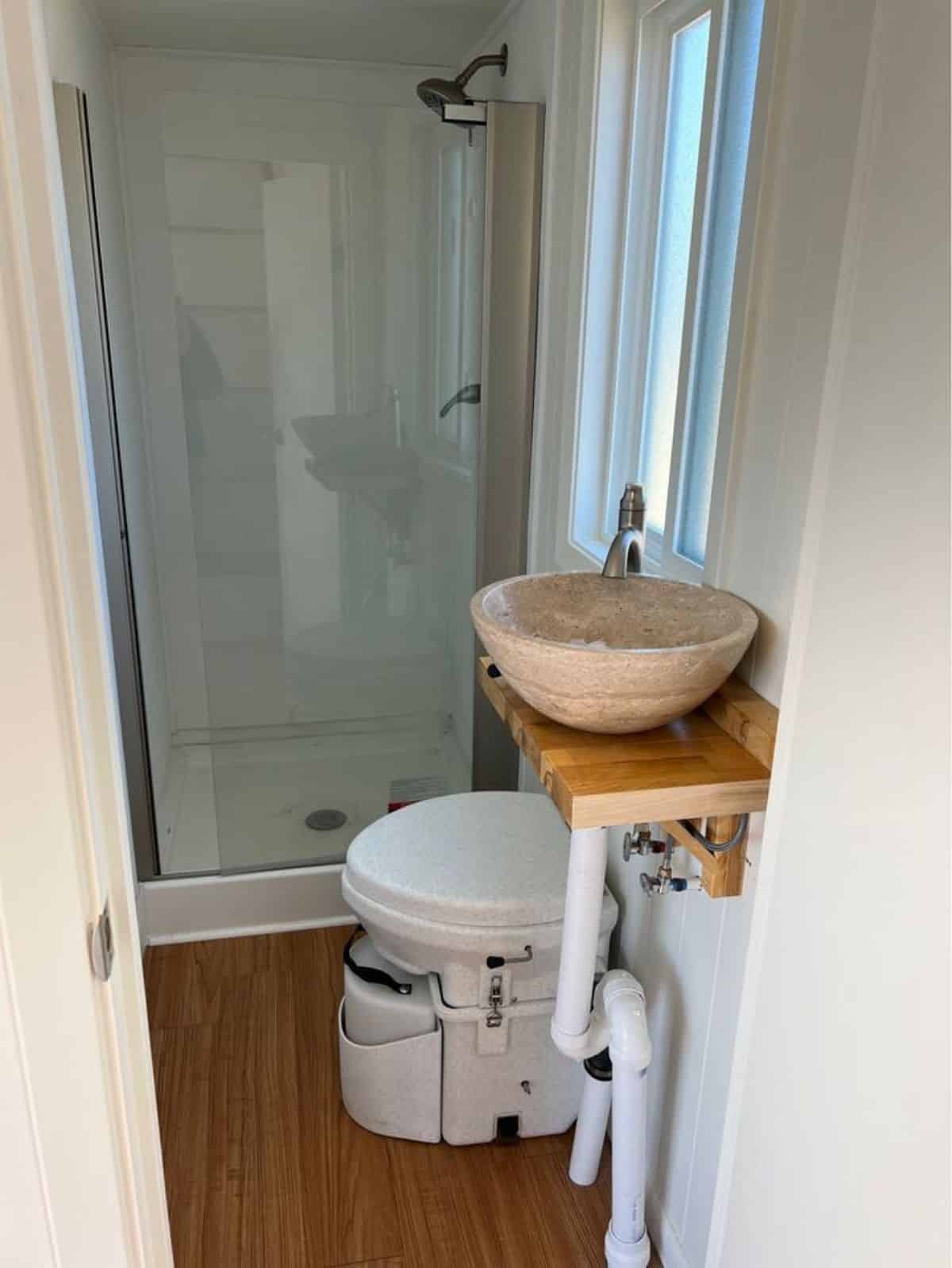 bathroom of tiny double lofted home has all the standard fittings and composting toilet