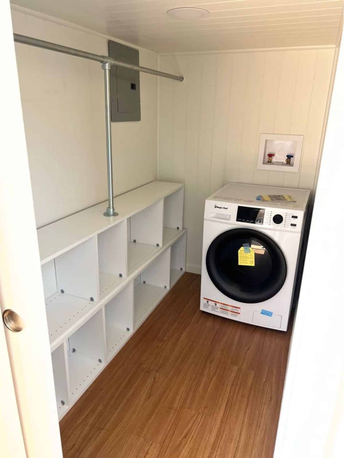 laundry room with storage cabinets and washer dryer combo