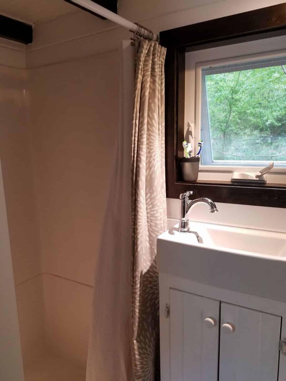 sink with vanity and separate shower area in bathroom