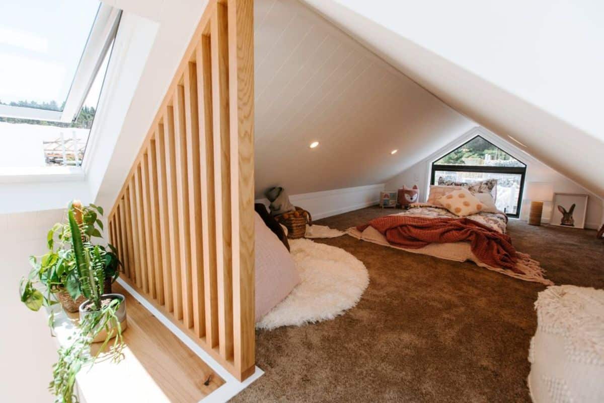 loft bedroom of 2 bedroom tiny house is super spacious with ample space